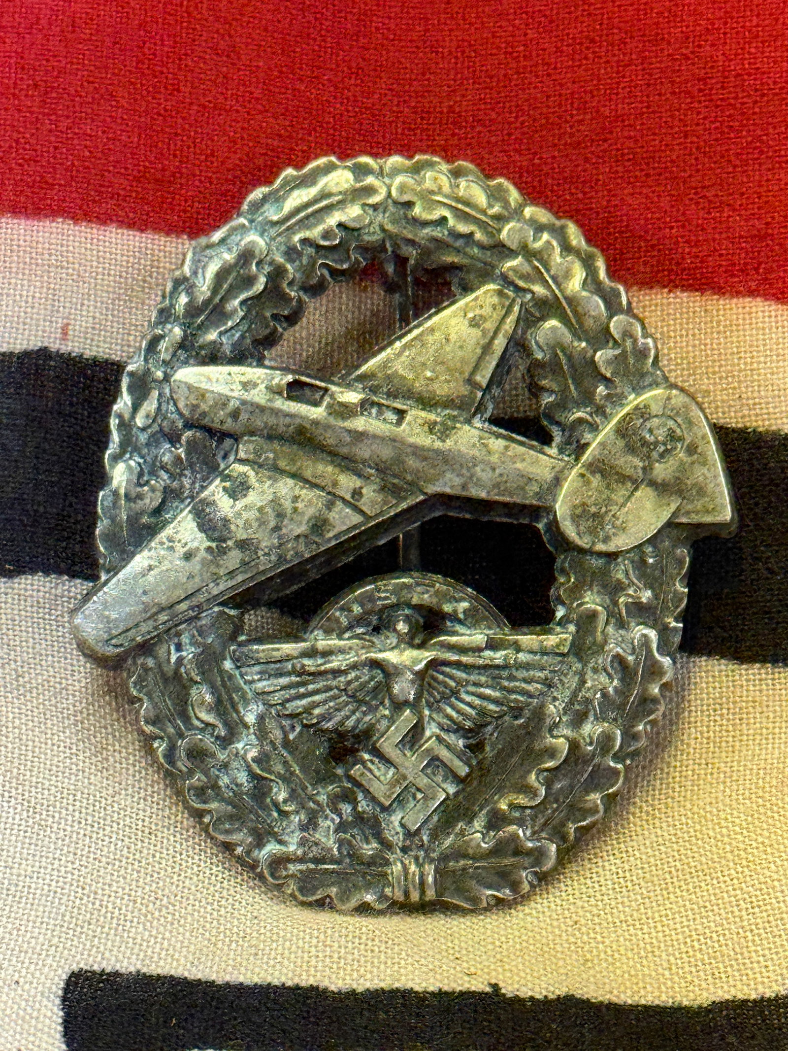 RARE WW2 GERMAN NSFK POWERED AIRCRAFT PILOT'S BADGE: RARE WW2 GERMAN NSFK POWERED AIRCRAFT PILOT'S BADGE. A VERY SCARCE EXAMPLE THAT IS IN MINT OVERALL SHAPE AND CONDITION WITH A BEAUTIFUL OVERALL PATINA. SHOWS GOOD WEAR AND USE. A VERY RARE EXAMPLE.