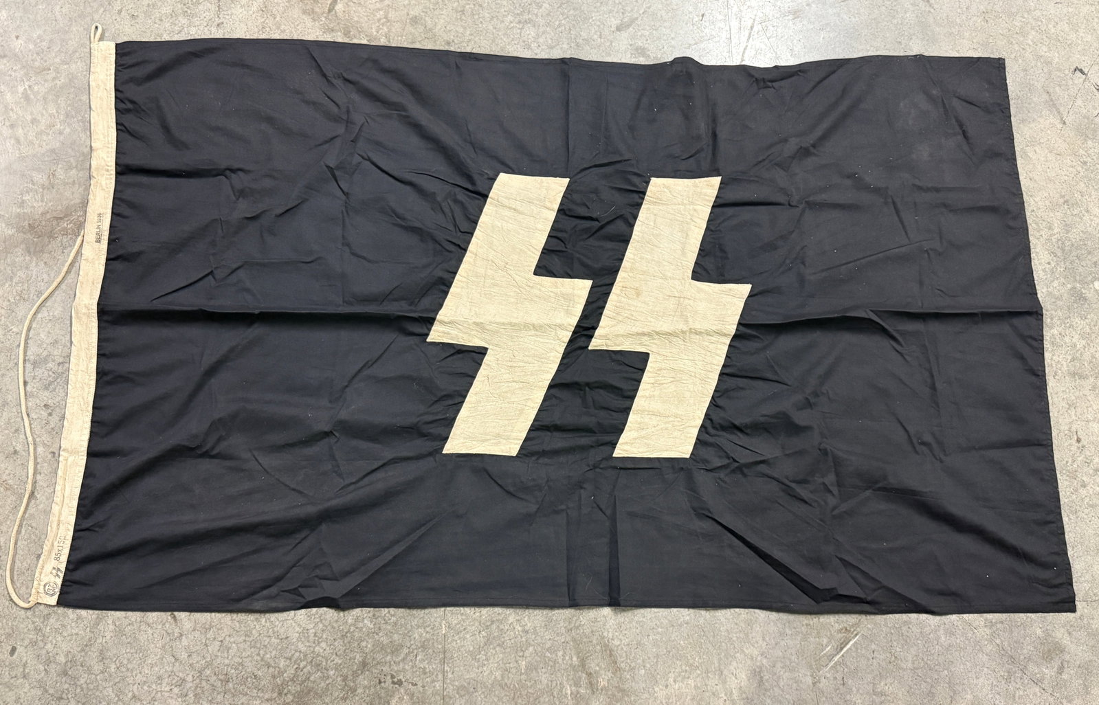 WW2 GERMAN WAFFEN-SS LARGER FLAG 85X150 MARKED SS RZM: WW2 GERMAN WAFFEN-SS LARGER FLAG 85X150 MARKED SS RZM. AN ULTRA RARE FIND THAT IS IN MINT OVERALL SHAPE AND CONDITION WITH A BEAUTIFUL OVERALL PATINA. VERY WELL PRESERVED AND COLLECTED. COMES FROM A L
