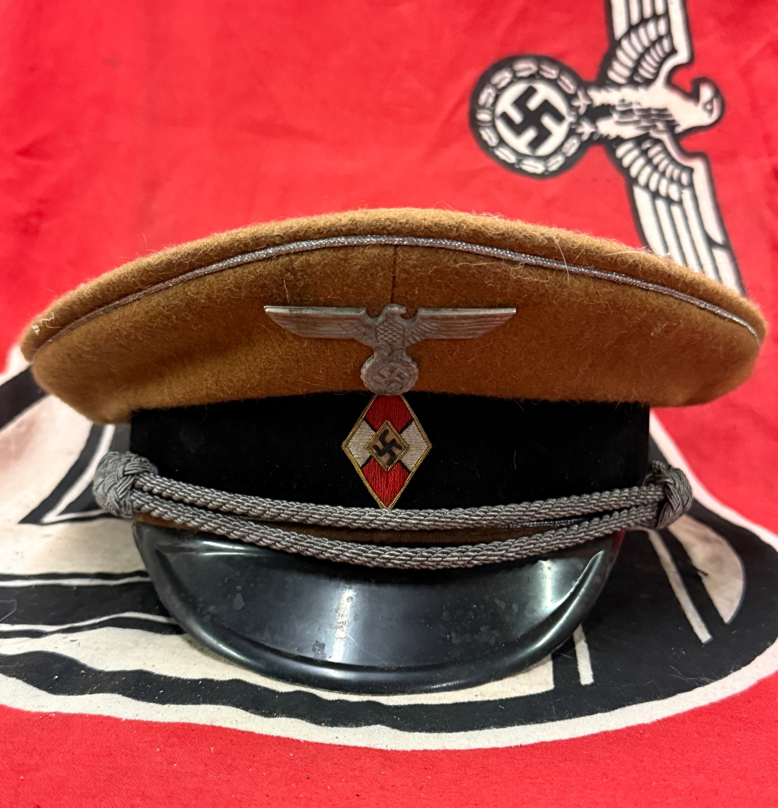 MAKER MARKED WW2 GERMAN HITLER YOUTH LEADER VISOR CAP WITH RZM PAPER TAG: MAKER MARKED WW2 GERMAN HITLER YOUTH LEADER VISOR CAP WITH RZM PAPER TAG. A VERY RARE FIND. SHOWS GOOD WEAR AND USE WITH A BEAUTIFUL OVERALL PATINA. HAS THE RZM PAPER TAG ATTACHED TO THE INSIDE WITH T