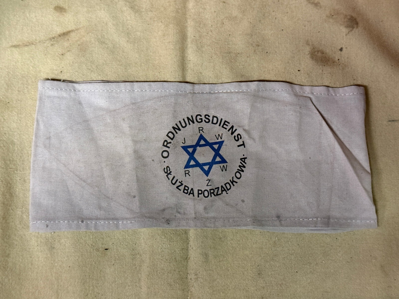WWII HOLOCAUST JEWISH GHETTO POLICE ARMBAND: WWII HOLOCAUST JEWISH GHETTO POLICE ARMBAND. A RARE FIND. SHOWS GOOD WEAR AND USE WITH A BEAUTIFUL OVERALL PATINA. A VERY RARE EXAMPLE.