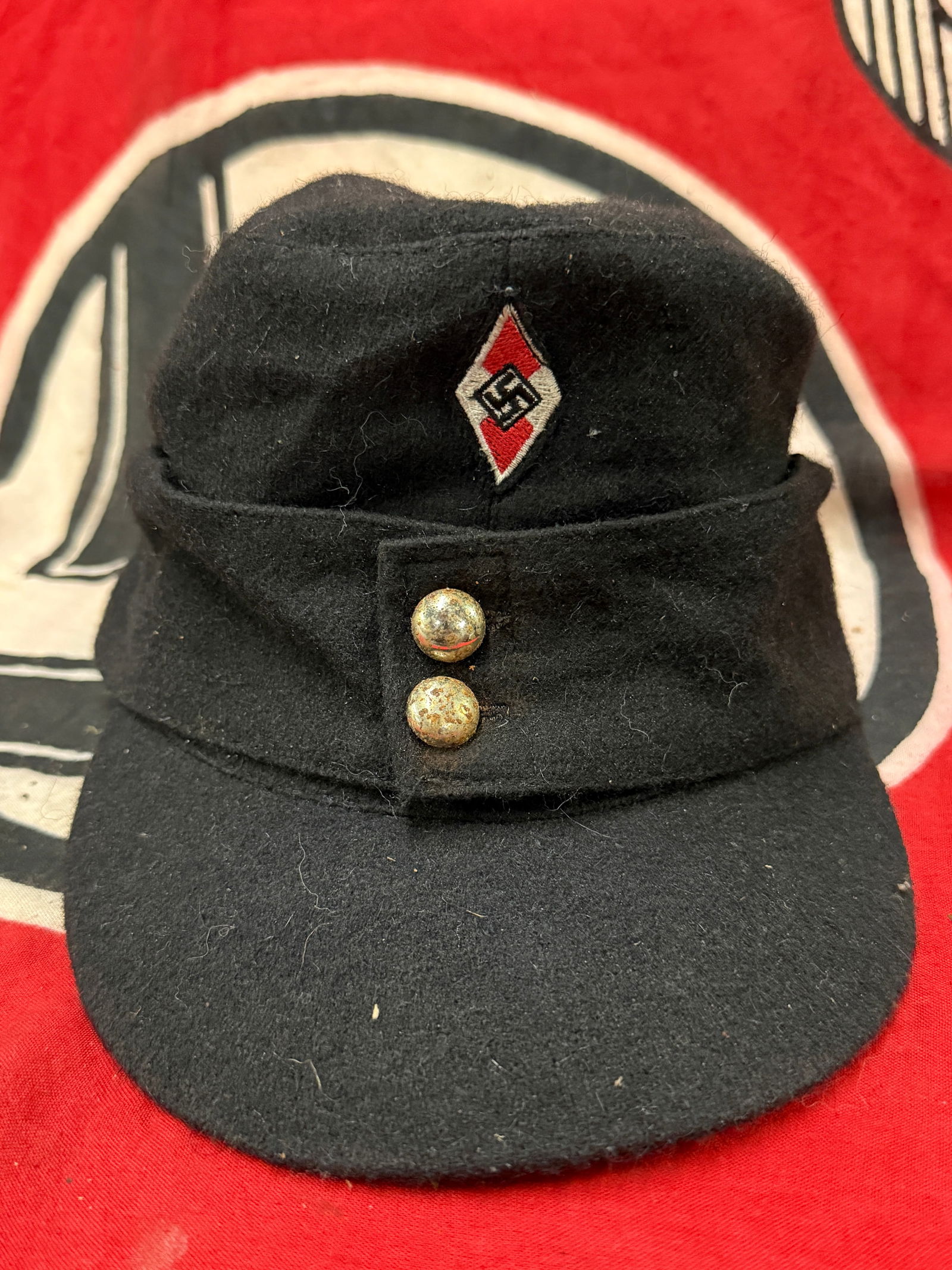 RARE WW2 GERMAN HITLER YOUTH M-43 SKI CAP WITH MAKER STAMP: RARE WW2 GERMAN HITLER YOUTH M-43 SKI CAP WITH MAKER STAMP. A VERY RARE FIND. SHOWS GOOD WEAR AND USE WITH A BEAUTIFUL OVERALL PATINA. HAS THE MAKER STAMP AND THE INSPECTION MARKINGS ON THE INSIDE. A