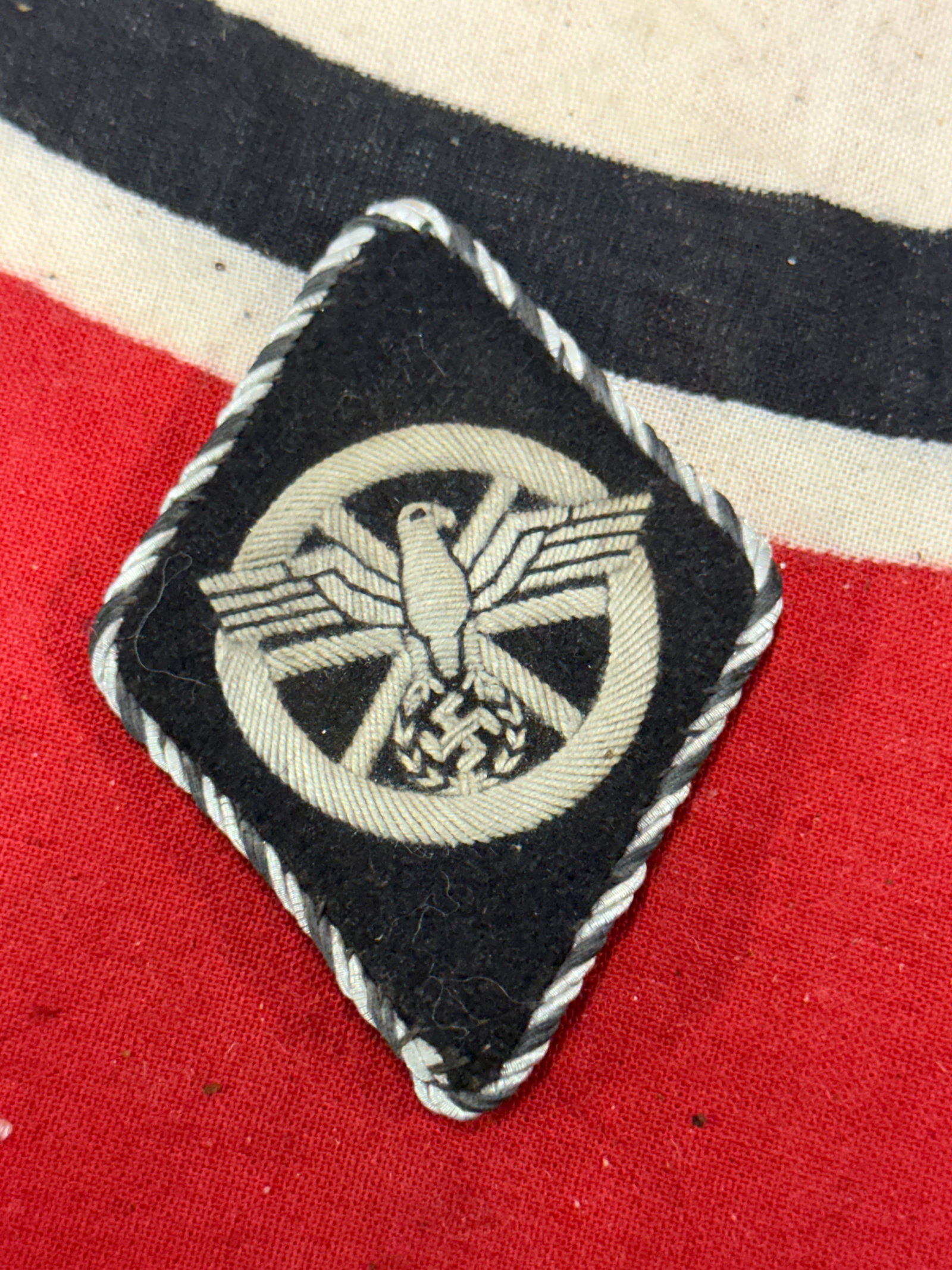 WW2 GERMAN SS/NSKK RAUTE IN BULLION: WW2 GERMAN SS/NSKK RAUTE IN BULLION. This one is a fine bullion example, with candy-stripe piping for the earlier period. Exquisitely rendered and no damage whatsoever.