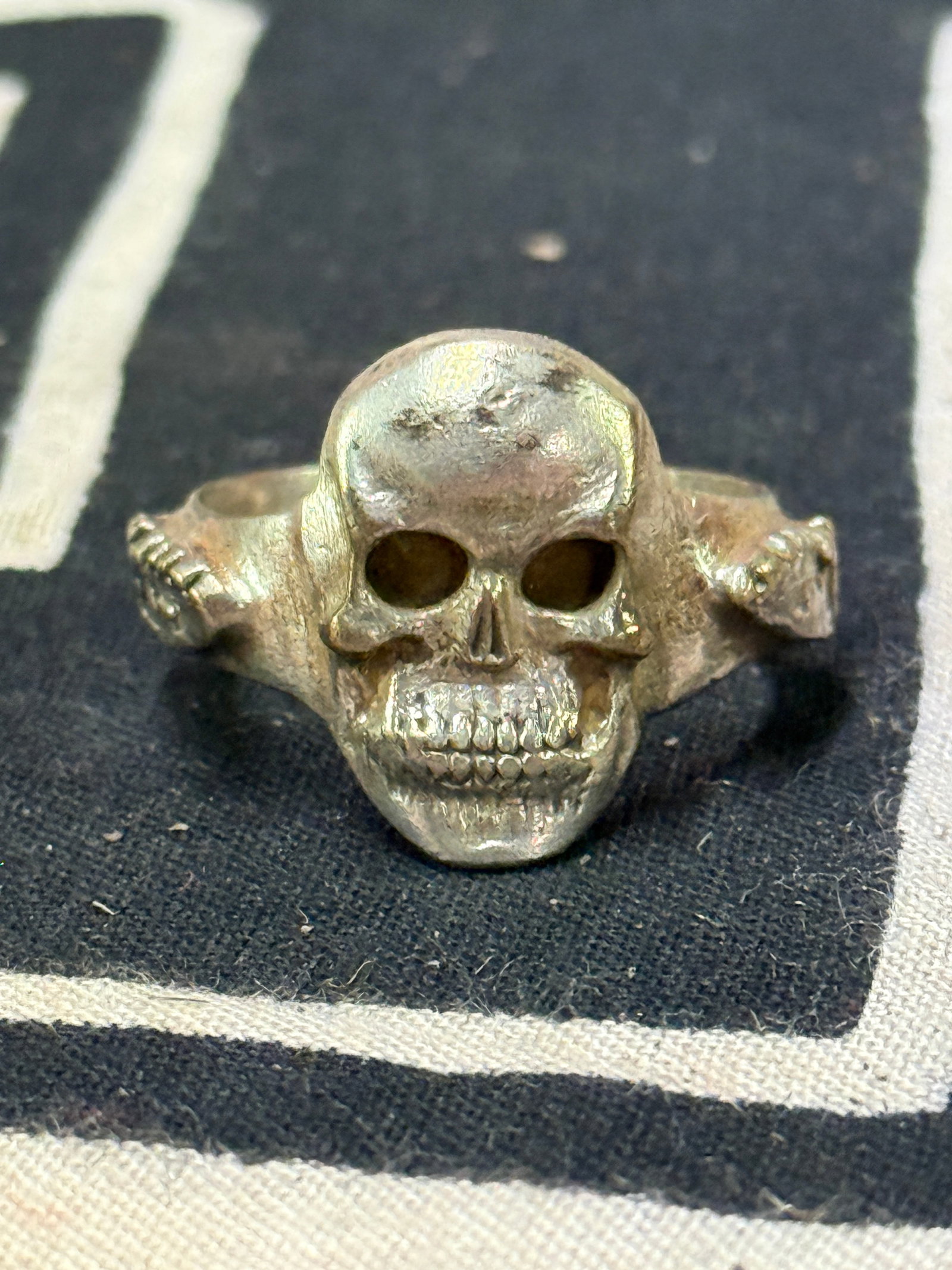 WW2 GERMAN TOTENKOPF SS 800 SILVER SKULL RING: WW2 GERMAN TOTENKOPF SS 800 SILVER SKULL RING. WORN BY A GERMAN SOLDIER IN THE SS ARMY. SHOWS GOOD WEAR AND USE WITH A BEAUTIFUL OVERALL PATINA. HAS THE TOTENKOPF SS SKULL ON THE FRONT. VERY WELL USED