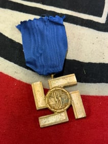 A WWII German SS 12 year service medal with ribbon