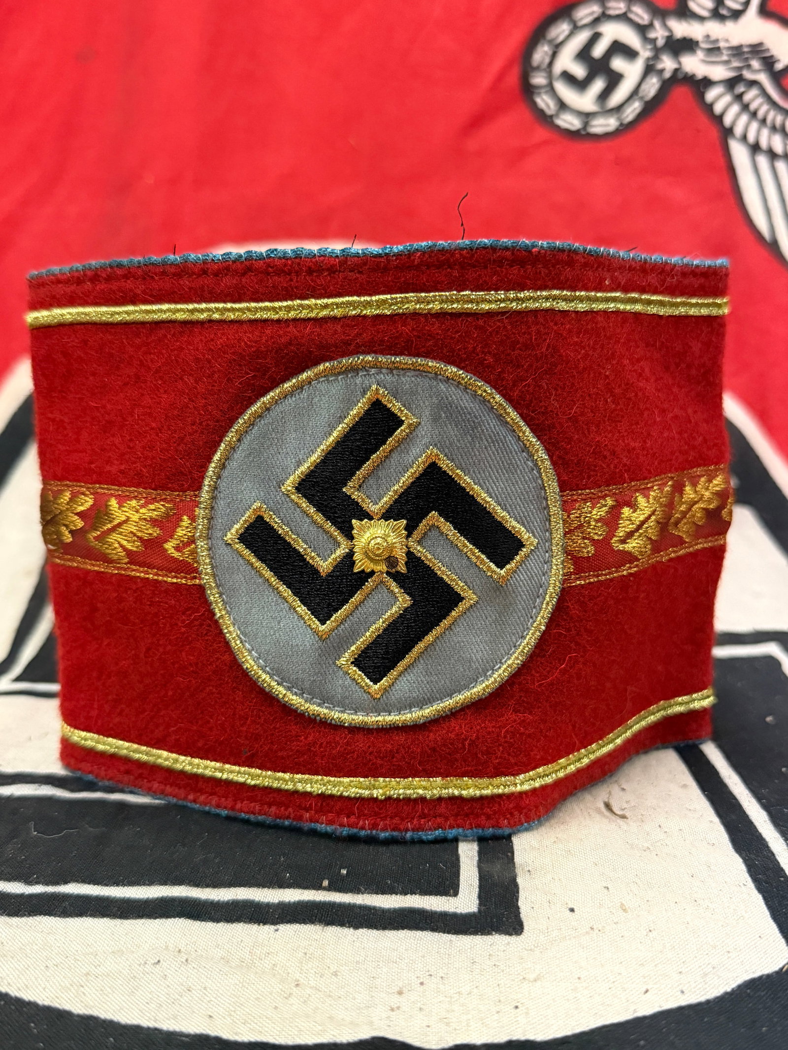 GERMAN 3RD REICH ARMBAND OF NSDAP POLITICAL LEADER WITH RZM PAPER TAG: GERMAN 3RD REICH ARMBAND OF NSDAP POLITICAL LEADER WITH RZM PAPER TAG. A German 3rd Reich armband of a very high ranking NSDAP political leader. Made of red felt with golden thread embroidery, feature