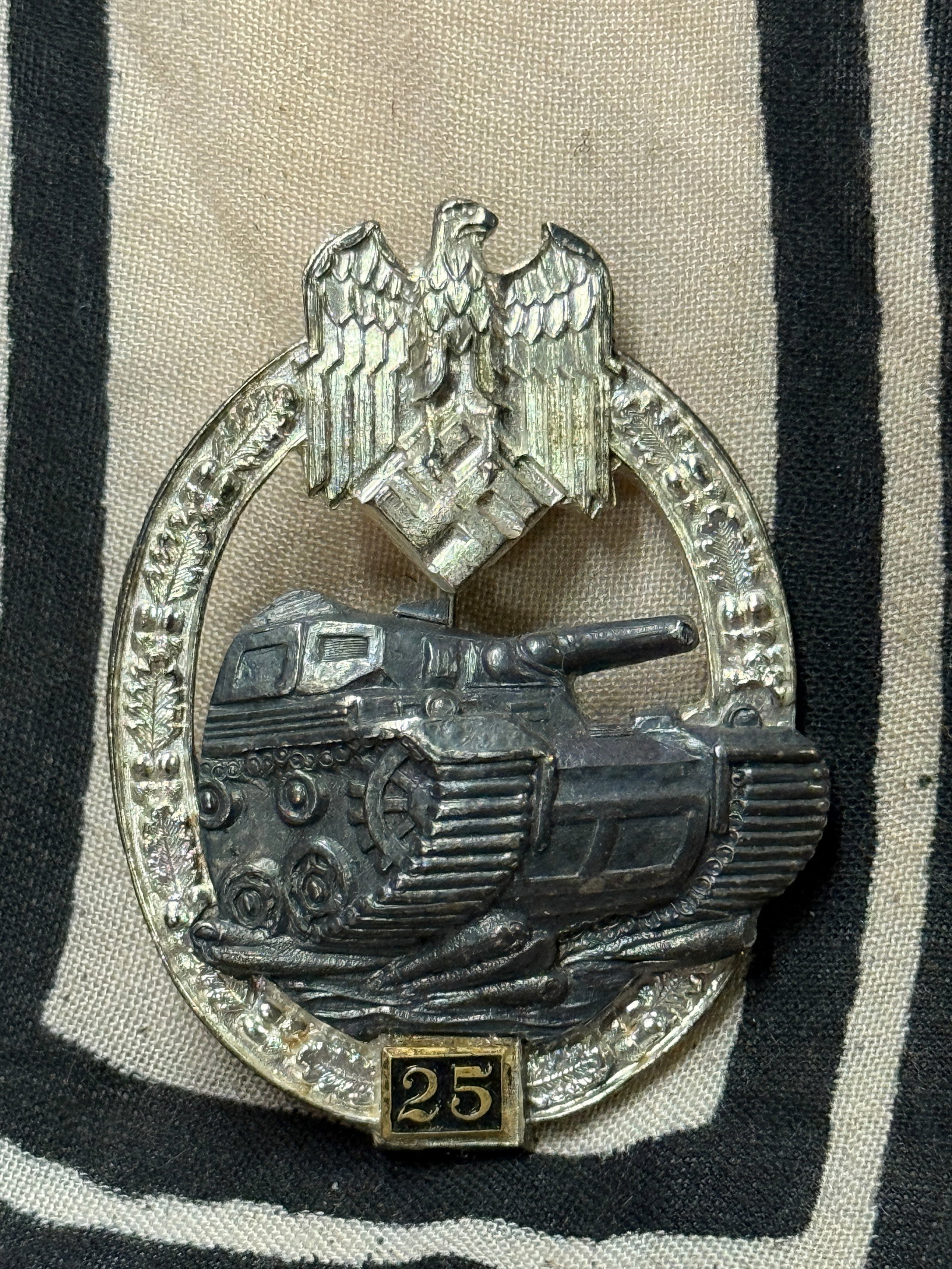 WW2 German Panzer assault badge in silver 25 assaults by Josef Feix: WW2 German Panzer assault badge in silver 25 assaults by Josef Feix. Panzer assault badge in silver 25 assaults by Josef Feix, Gablonz. Copper coated zink constructed wreath with riveted zink panzer a