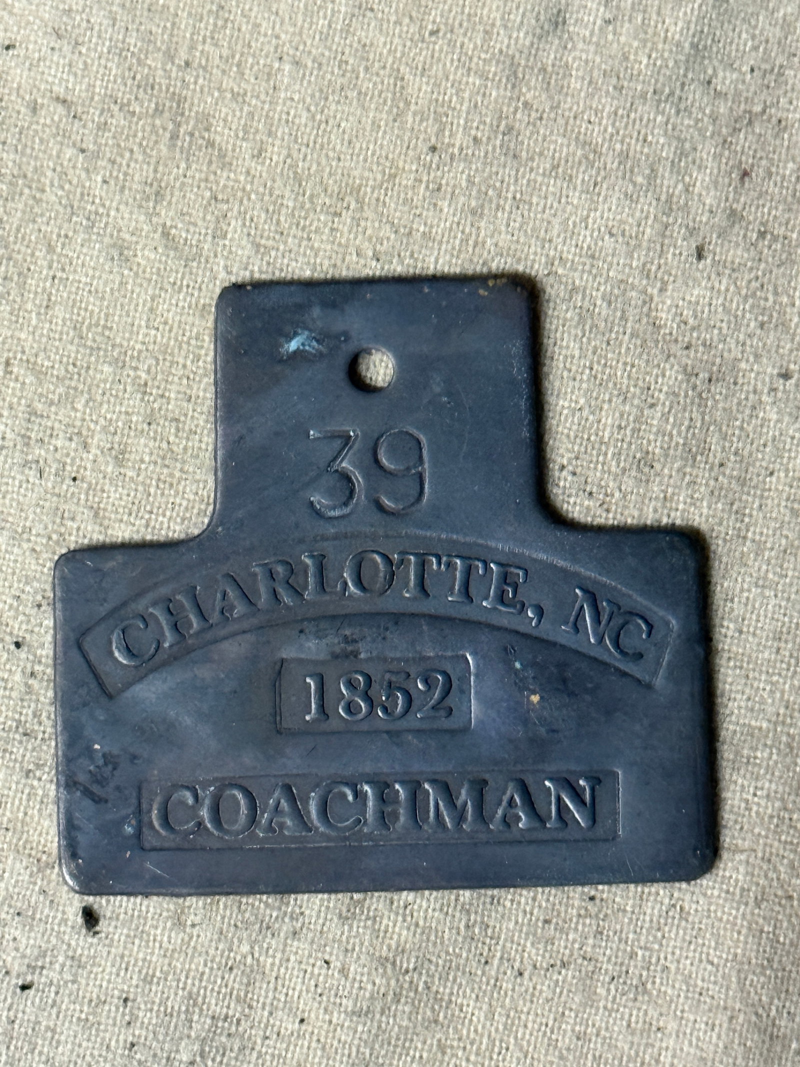 DATED 1852 CHARLOTTE, NC #39 COACHMAN SLAVE TAG SERVANT ID: DATED 1852 CHARLOTTE, NC #39 COACHMAN SLAVE TAG SERVANT ID. A RARE FIND. SHOWS GOOD WEAR AND USE WITH A BEAUTIFUL OVERALL PATINA. PLEASE VIEW ALL DETAILED PICTURES. A SCARCE EXAMPLE OF THE TIME PERIOD