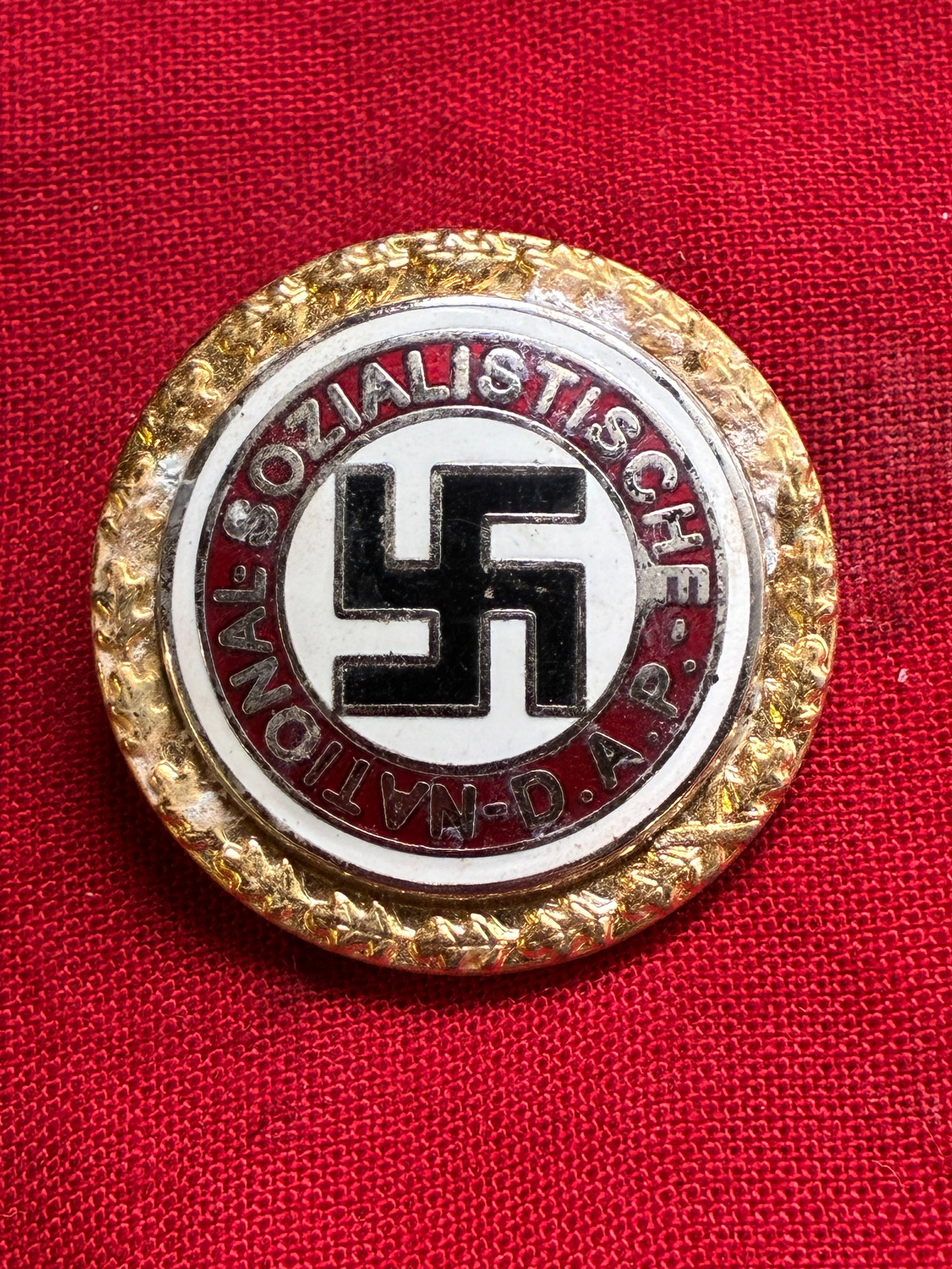 WWII GERMAN THIRD REICH NSDAP GOLDEN PARTY ENAMELED BADGE BY GES. GESCH. 50569: WWII GERMAN THIRD REICH NSDAP GOLDEN PARTY ENAMELED BADGE BY GES. GESCH. 50569. A VERY RARE EXAMPLE. SHOWS GOOD WEAR AND USE WITH A BEAUTIFUL OVERALL PATINA. PLEASE VIEW ALL DETAILED PICTURES. A SCARC