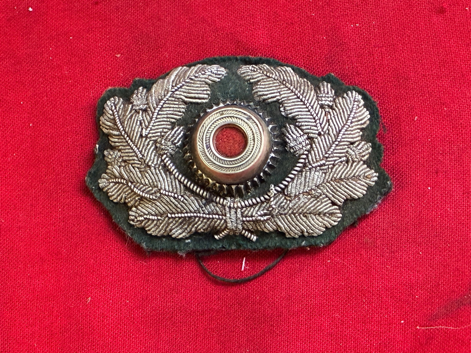 German WWII Heer Officer’s Visor Wreath & Cockade in Silver Bullion: German WWII Heer Officer’s Visor Wreath & Cockade in Silver Bullion. Shows good wear and use with a beautiful overall patina. The Heer was the land forces component of the Wehrmacht, the regular Ger