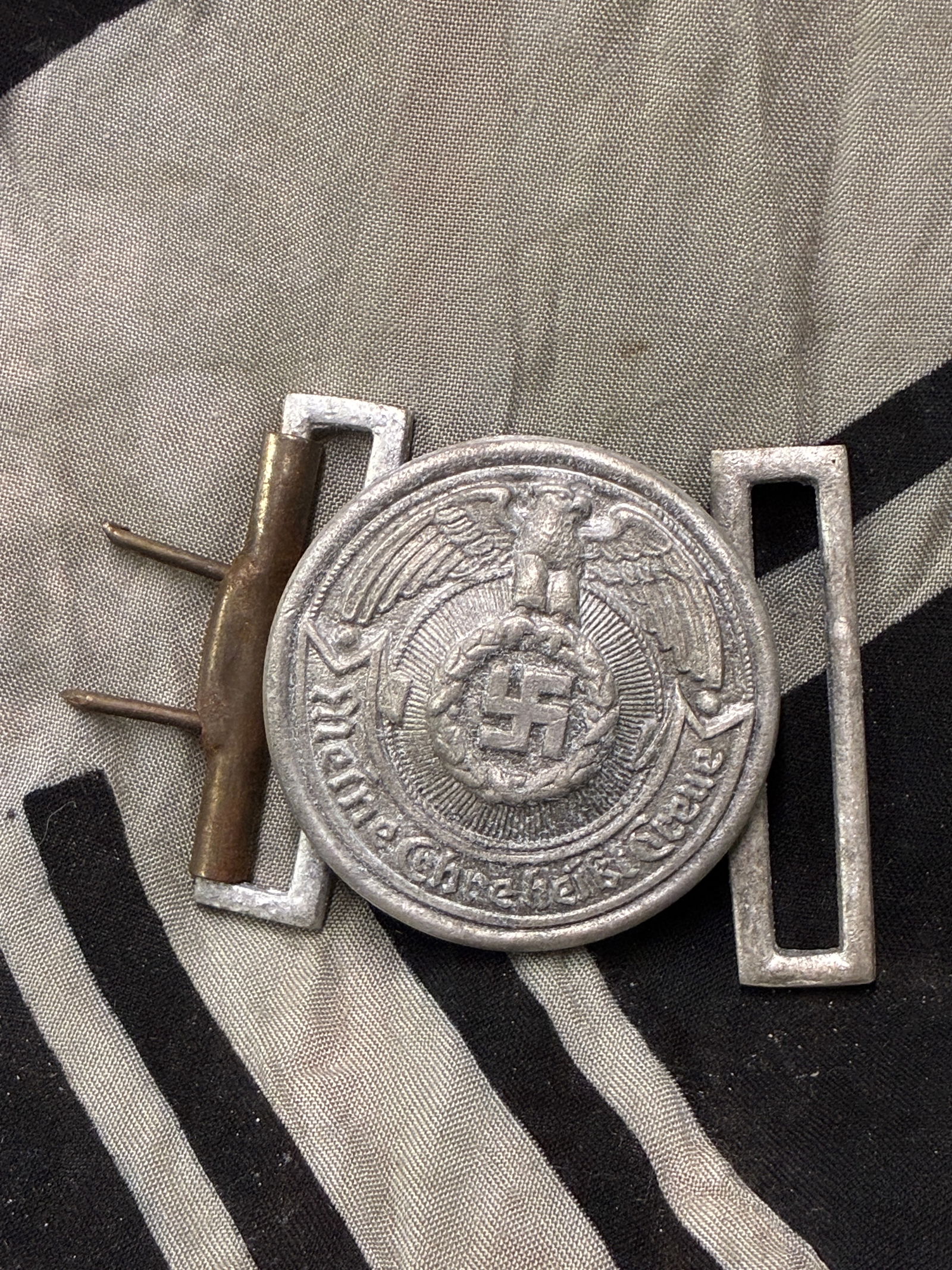 RARE WW2 GERMAN WAFFEN SS OFFICER'S ALUMINUM BELT BUCKLE BY RZM: RARE WW2 GERMAN WAFFEN SS OFFICER'S ALUMINUM BELT BUCKLE BY RZM. A RARE FIND. SHOWS GOOD WEAR AND USE WITH A BEAUTIFUL OVERALL PATINA. MAKER MARKED ON THE REVERSE. A VERY RARE FIND.