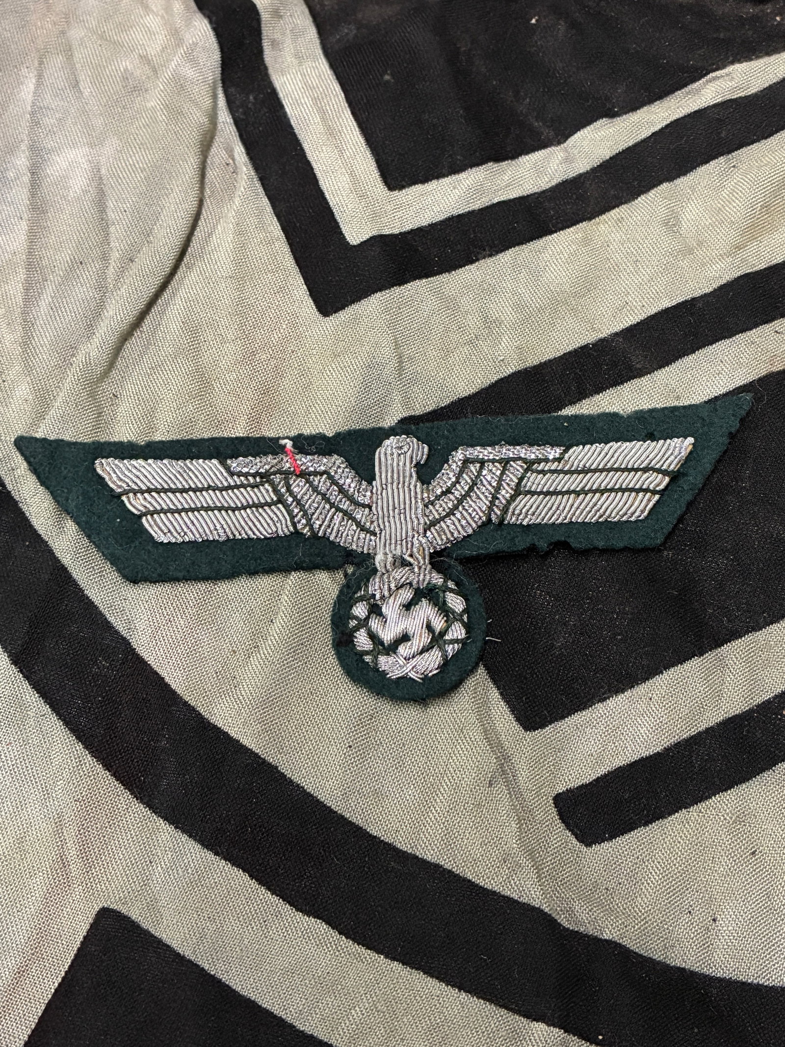 German WWII Heer Officers Breast Eagle In Bullion: German WWII Heer Officers Breast Eagle In Bullion. Hand embroidered in silver bullion wire on dark green cloth. Retains backing since the threads are sewn through it.