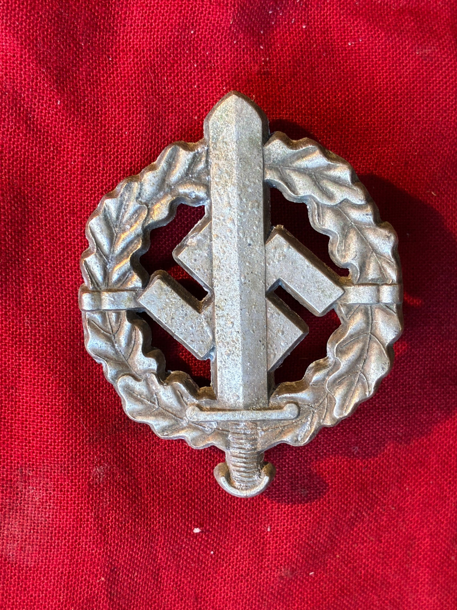 WW2 German SA Sports Badge in Silver by W. Redo: WW2 German SA Sports Badge in Silver by W. Redo. W. Redo maker marked SA sports badge in silver. Minor oxidation but regardless as can be seen in the photos it looks remarkable on display. The SA Spor