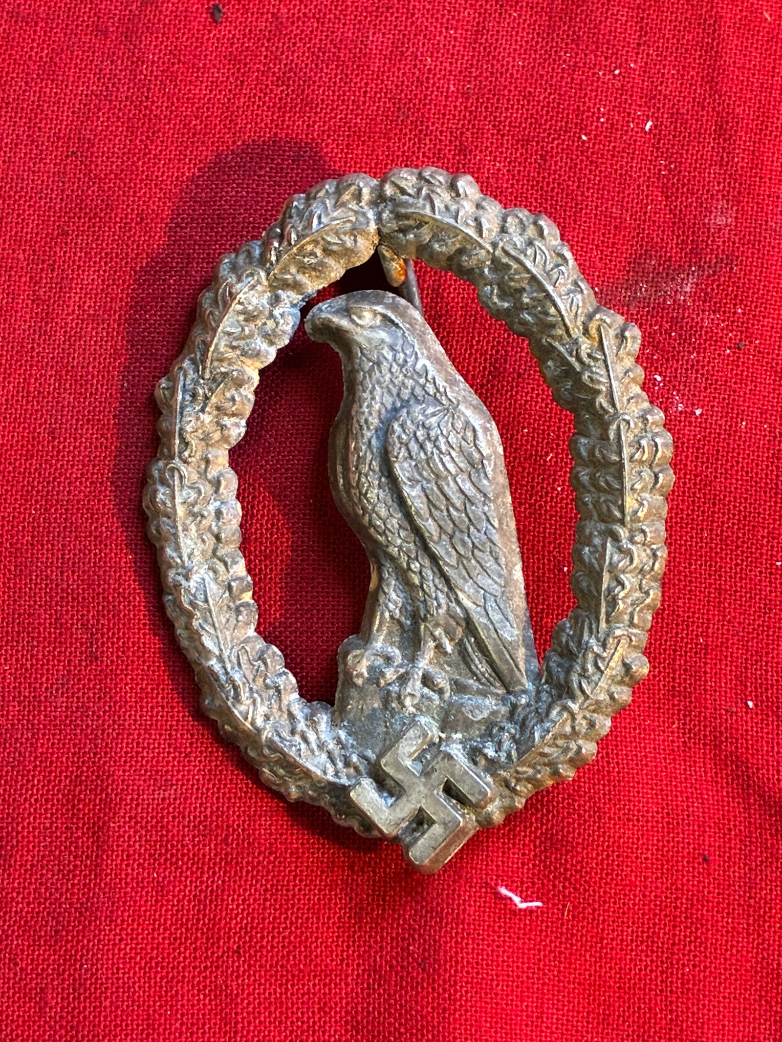 A RARE GERMAN WWII RETIRED LUFTWAFFE PILOT BADGE BY JFS: A RARE GERMAN WWII RETIRED LUFTWAFFE PILOT BADGE BY JFS. A rare Retired Luftwaffe Pilot's Badge in a very good condition. Stamped on the reverse JFS. Executed in silvered fine zinc, pin-back construct
