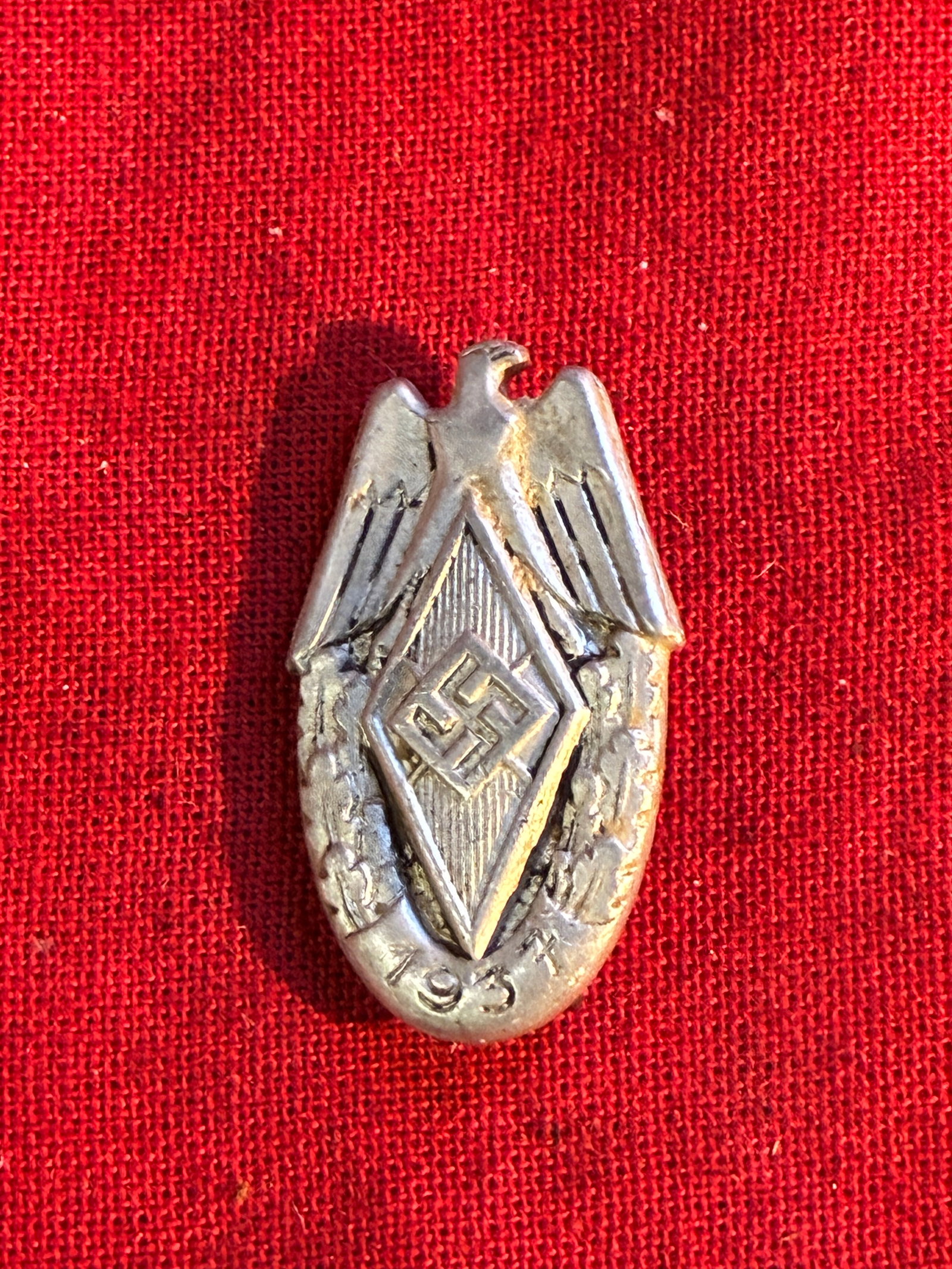 WW2 German Hitler Youth 1938 Sports Badge: WW2 German Hitler Youth 1938 Sports Badge. Features the symbols of the HJ movement the diamond, the national eagle. Retains an original blue wash making the wreath and date more prominent. Maker marke