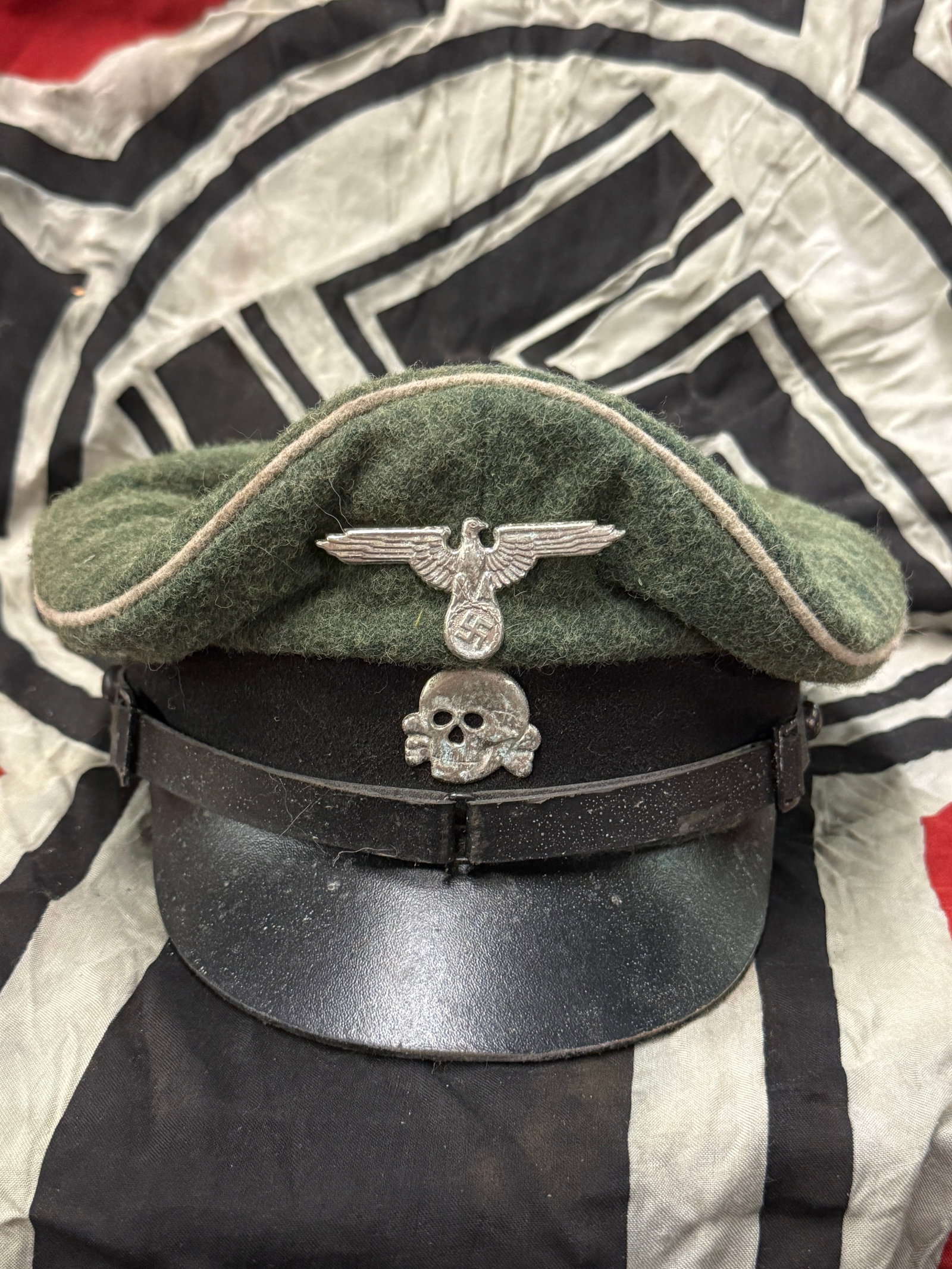 WWII GERMAN REICH WAFFEN SS CAP WITH MAKER MARKS AND RZM PAPER TAG: WWII GERMAN REICH WAFFEN SS CAP WITH MAKER MARKS AND RZM PAPER TAG. SHOWS GOOD WEAR AND USE WITH A BEAUTIFUL OVERALL PATINA. HAS THE MAKER MARKS ON THE INSIDE LINER WITH THE RZM PAPER TAG. PLEASE VIEW