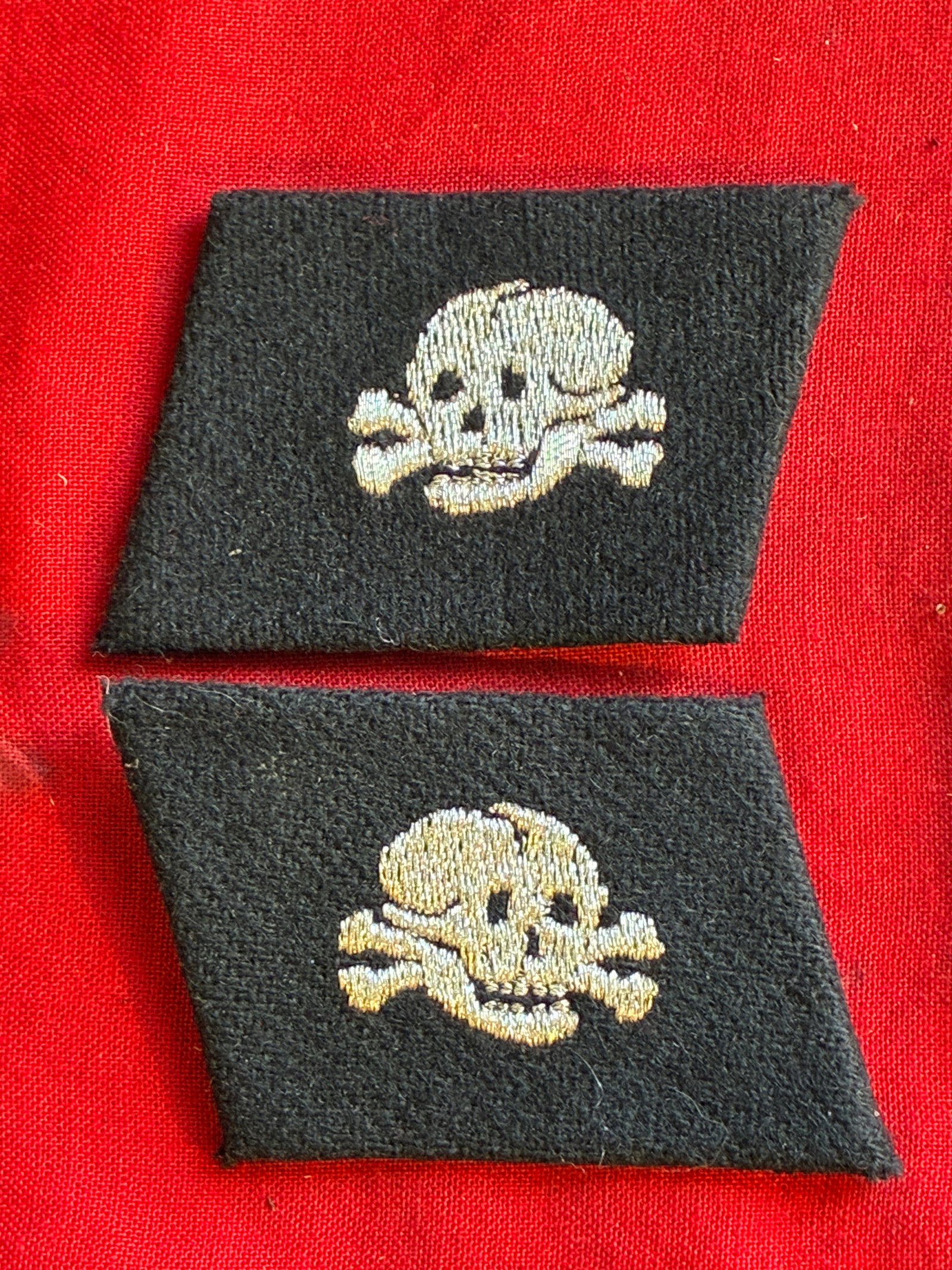 PAIR OF WW2 GERMAN TOTENKOPF DEATH'S HEAD COLLAR TABS WITH RZM PAPER TAG: PAIR OF WW2 GERMAN TOTENKOPF DEATH'S HEAD COLLAR TABS WITH RZM PAPER TAG ATTACHED TO THE REVERSE. AN ULTRA RARE FIND THAT IS IN MINT OVERALL SHAPE AND CONDITION WITH A BEAUTIFUL OVERALL PAITNA. SHOWS 