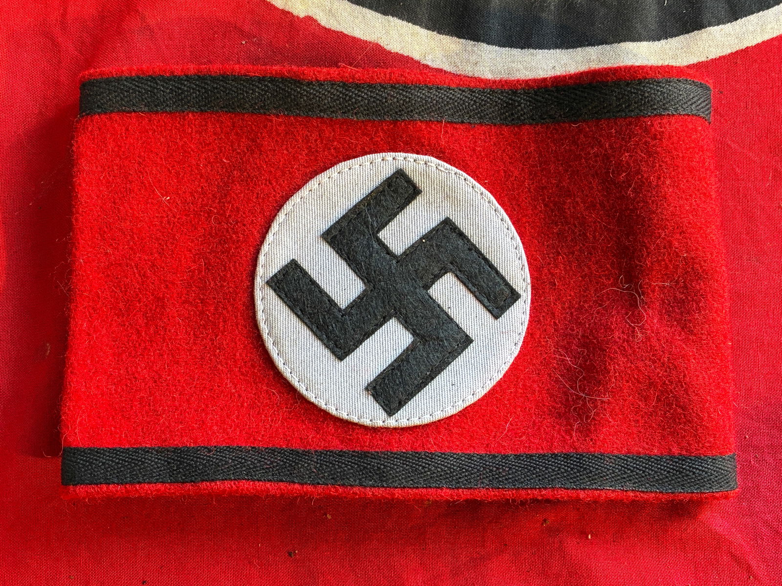 German WWII SS Member's Wool & Rayon Multi-Piece Armband with Paper SS RZM Tag: German WWII SS Member's Wool & Rayon Multi-Piece Armband with Paper SS RZM Tag. The SS (Schutzstaffel - 'Protection Squadron') was originally formed in 1925, ostensibly to act as a small, loyal bodygu