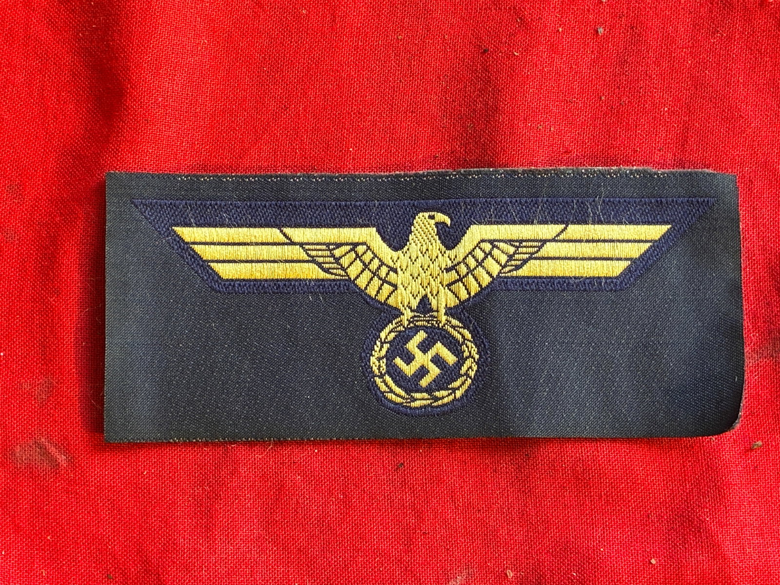 WW2 German KM/ EM/NCO’S Overseas Cap Eagle: Badge for EM/NCO´s caps of KM (Mützen Adler) machine-woven, yellow eagle on blue cloth base, the badge is still in its original condition, coming from a factory roll, never worn.
