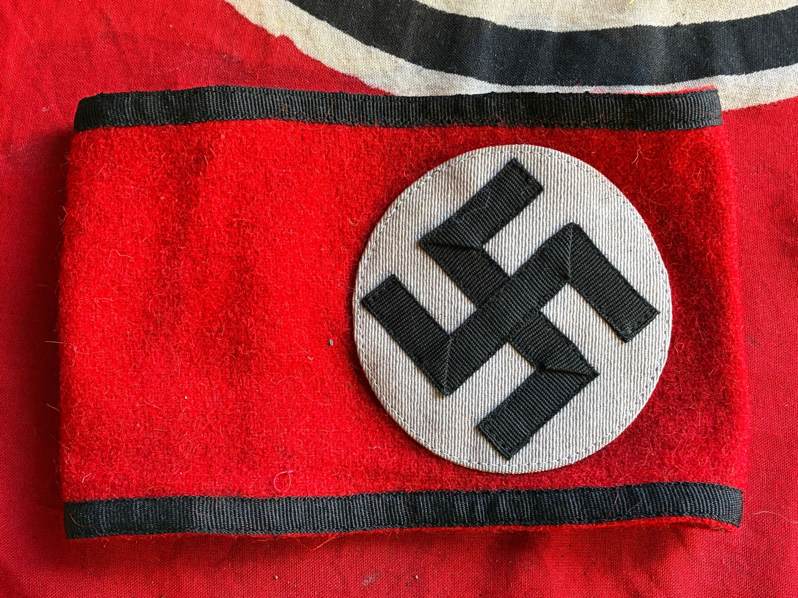 WW2 German ALLGEMEINE SS Armband w/ RZM Tag: WW2 German ALLGEMEINE SS Armband w/ RZM Tag. Nice multi-piece construction armband features a red wool base field with a central, vertically ribbed, white rayon, circular field with a canted, ribbed,