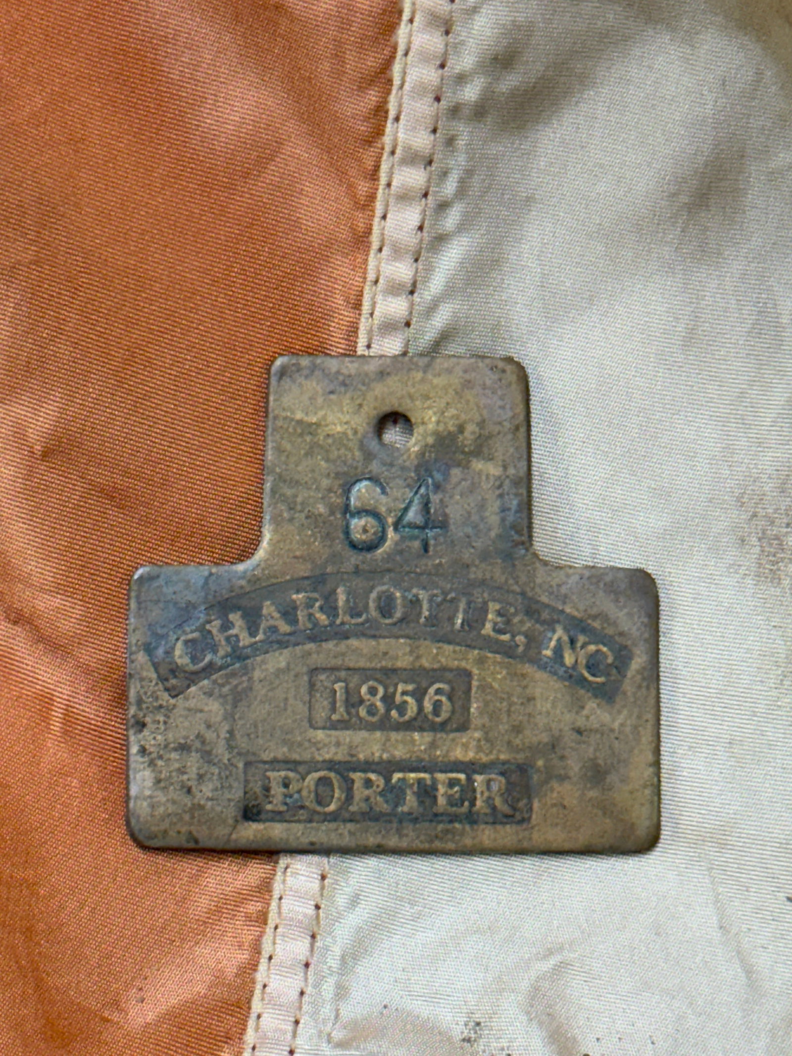 DATED 1856 #64 CHARLOTTE, NC PORTER SLAVE TAG SERVANT ID: DATED 1856 #64 CHARLOTTE, NC PORTER SLAVE TAG SERVANT ID. A VERY RARE EXAMPLE THAT IS IN MINT OVERALL SHAPE AND CONDITION WITH A BEAUTIFUL OVERALL PATINA. HAS A GREAT LOOK TO IT WITH AN EXCELLENT OVER