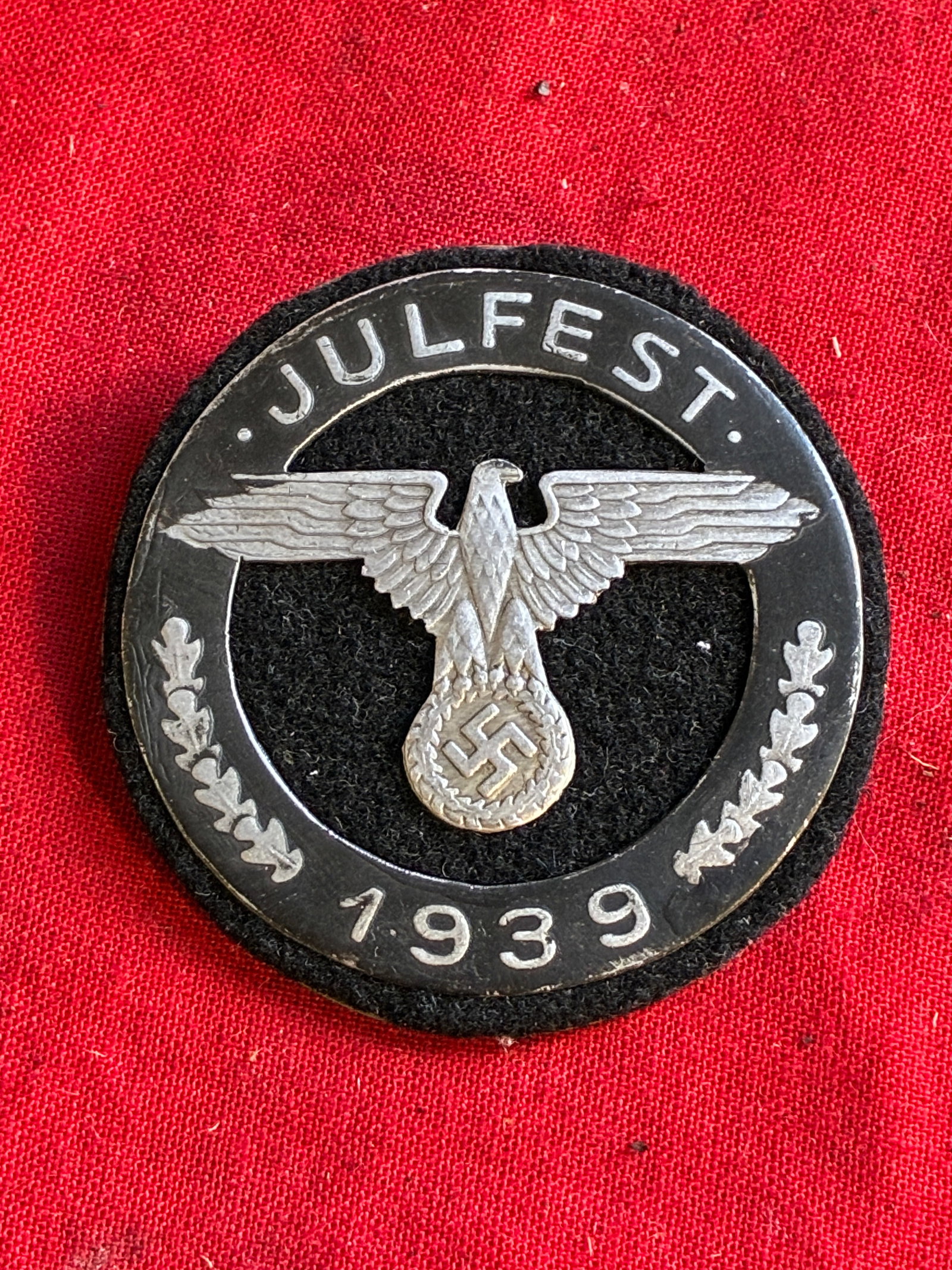 WW2 German SS Julfest 1939 Tinnie badge By Wittmann Munchen: WW2 German SS Julfest 1939 Tinnie badge By Wittmann Munchen. Die stuck out of a light alloy. Pin on rear. Please view all detailed pictures. A rare example of the time period.