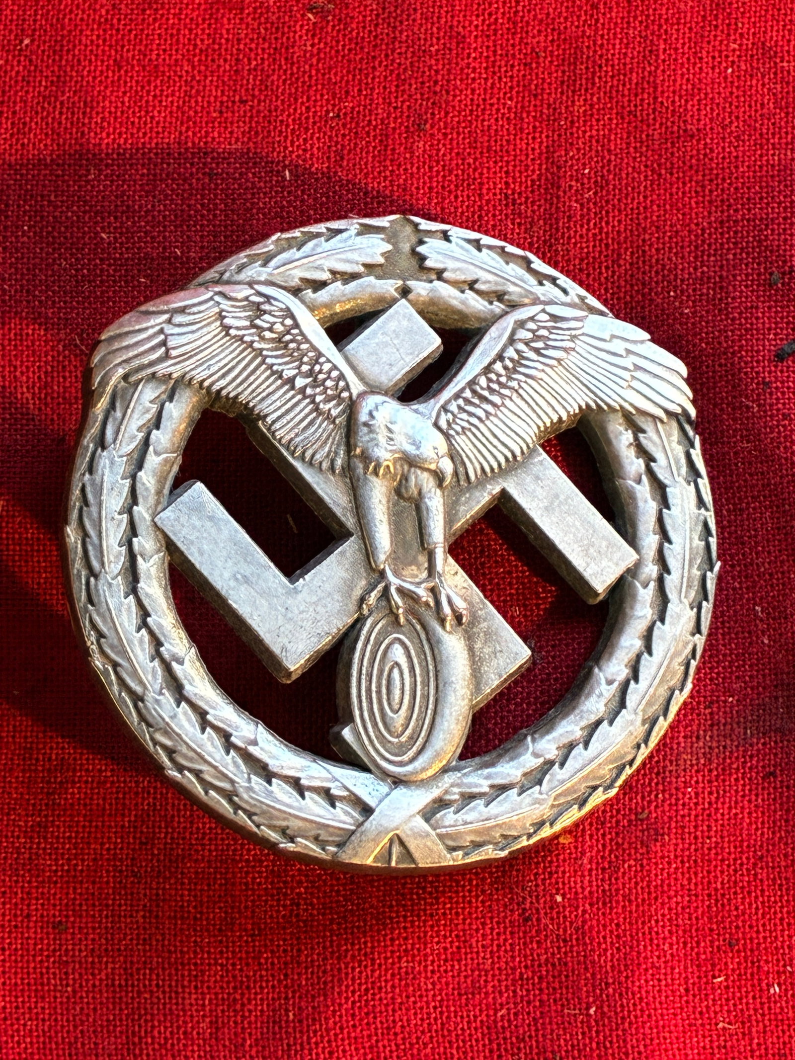 WWII GERMAN NSKK MOTORSPORTS BADGE IN 800 SILVER BY GES. GESCH.: WWII GERMAN NSKK MOTORSPORTS BADGE IN 800 SILVER BY GES. GESCH. Pin back. Maker marked "LN 1700" and stamped "800" on the reverse. Shows good wear and use. Please view all detailed pictures. A rare ex