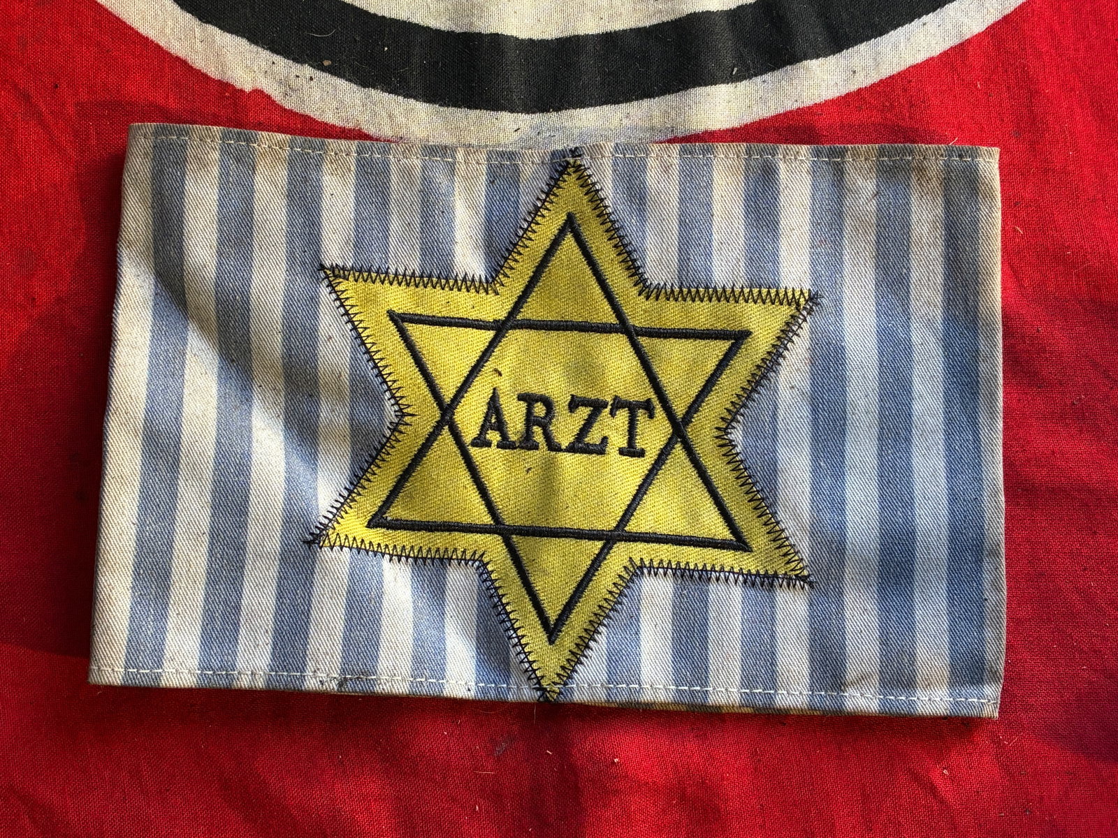 WW2 GERMAN ARZT DOCTOR OR PHYSICIAN ARMBAND WITH STAR OF DAVID WORN IN GHETTOS: WW2 GERMAN ARZT DOCTOR OR PHYSICIAN ARMBAND WITH STAR OF DAVID WORN IN GHETTOS. A VERY RARE FIND. SHOWS GOOD WEAR AND USE WITH A BEAUTIFUL OVERALL PATINA. PLEASE VIEW ALL DETAILED PICTURES. A VERY RAR