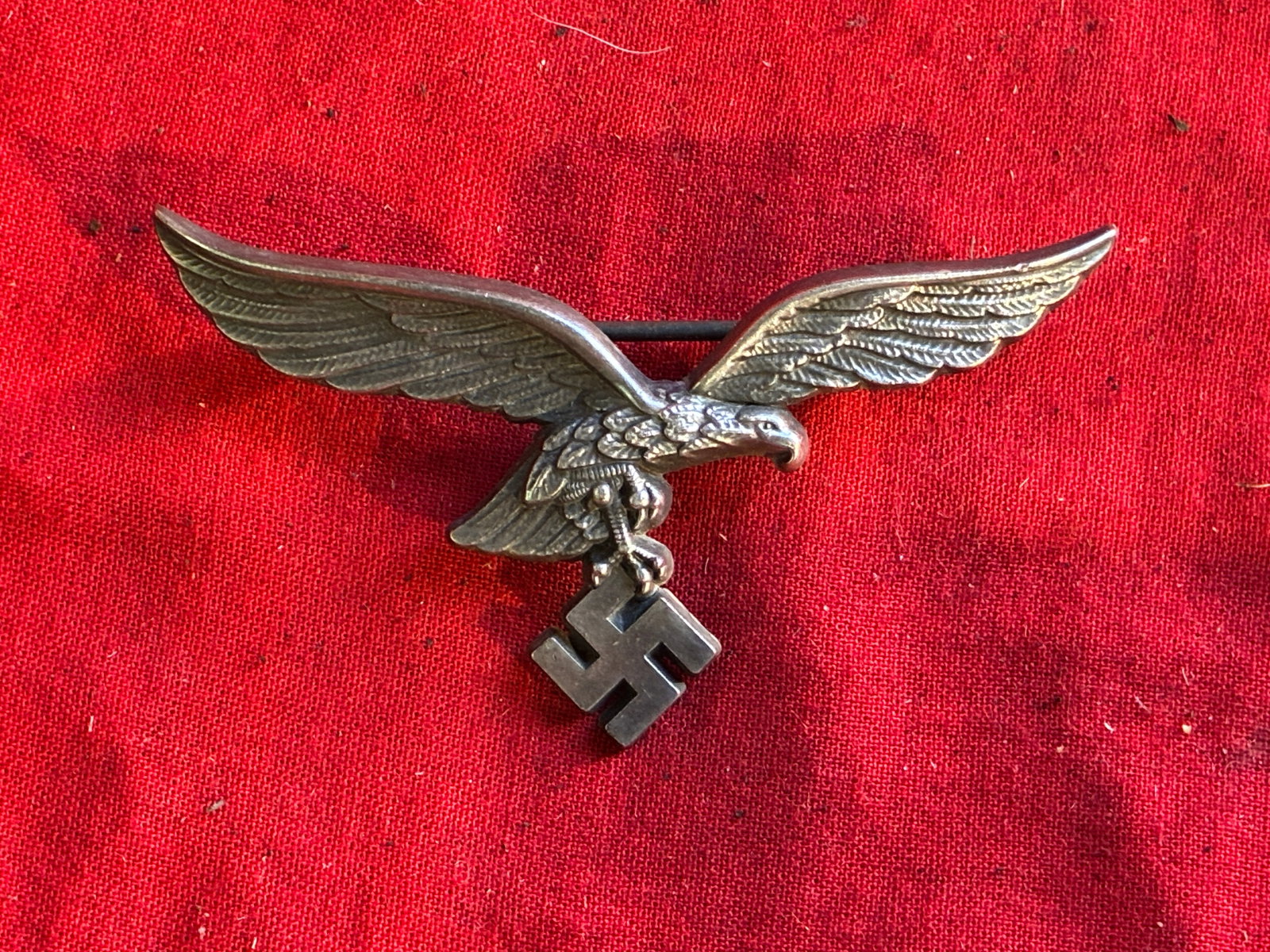 WWII GERMAN LUFTWAFFE OFFICER SUMMER BREAST EAGLE BY ASSMANN: German WWII Luftwaffe Summer Tunic Officers Breast Eagle. Measures 3 1/8” wide by 1 3/4" tall. The front shows a Luftwaffe flying eagle clutching a swastika in his talons. The reverse side is ma