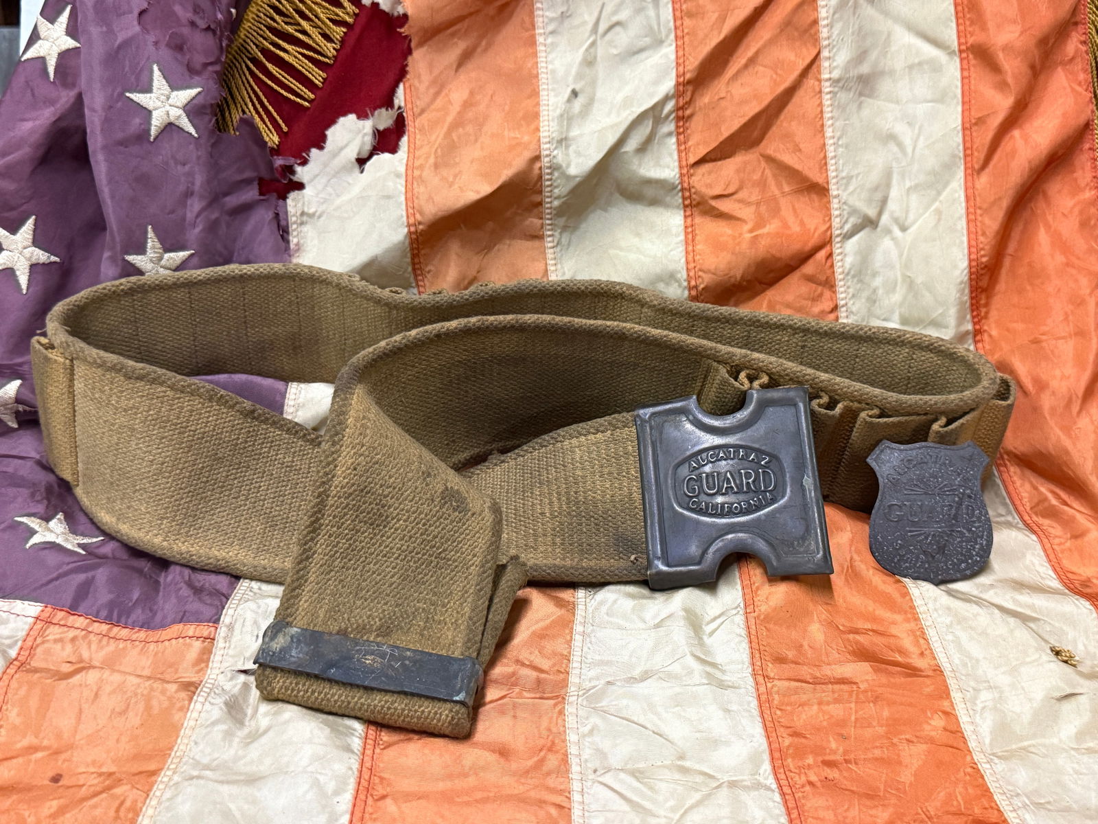 ANTIQUE ALCATRAZ GUARD CALIFORNIA BELT, BUCKLE, AND BADGE: ANTIQUE ALCATRAZ GUARD CALIFORNIA BELT, BUCKLE, AND BADGE. A VERY RARE FIND. SHOWS GOOD WEAR AND USE WITH A BEUATIFUL OVERALL PATINA. PLEASE VIEW ALL DETAILED PICTURES. A VERY RARE FIND AND AN EXCELLE