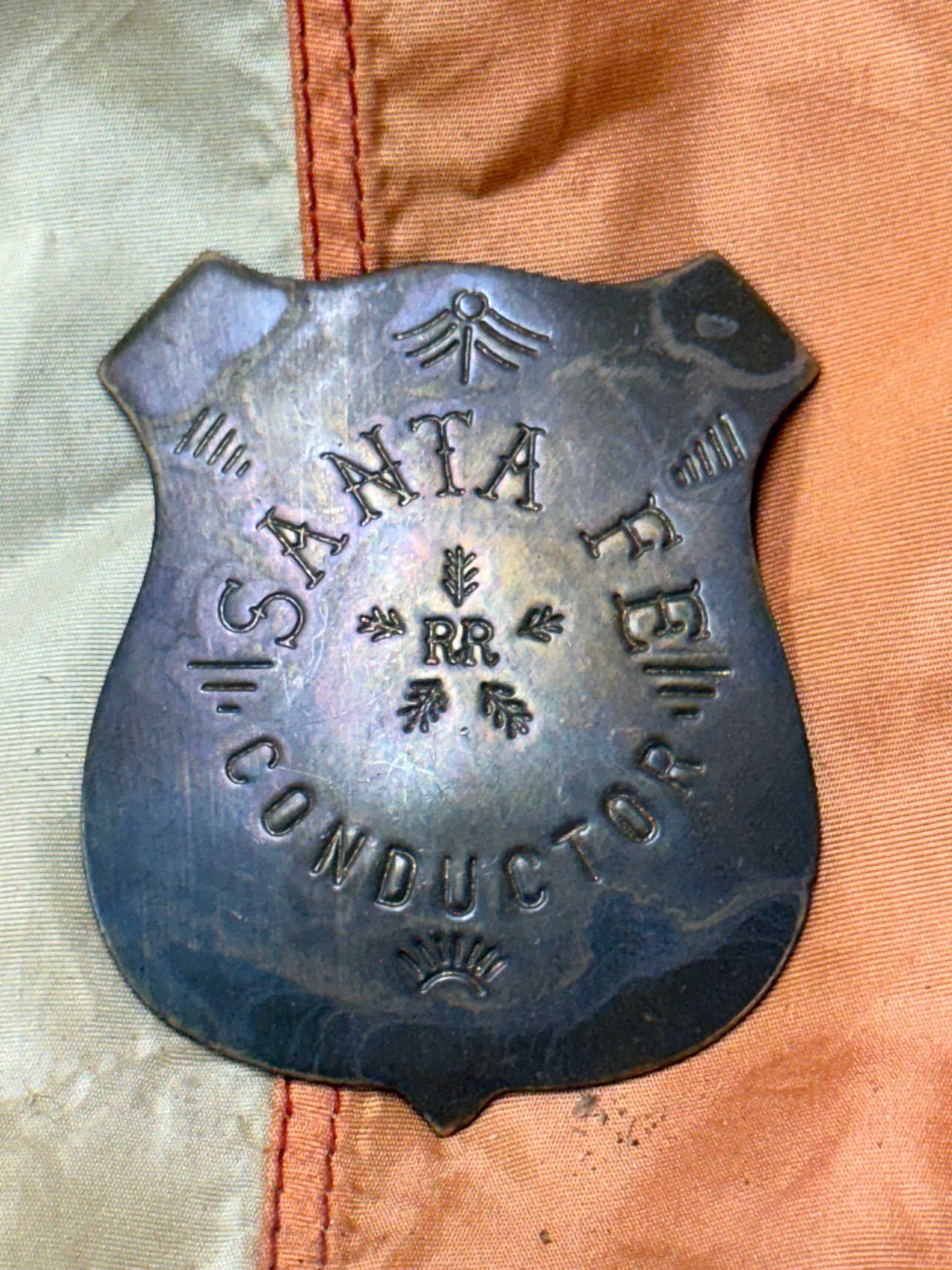 ANTIQUE 1800'S SANTA FE CONDUCTOR BADGE: ANTIQUE 1800'S SANTA FE CONDUCTOR BADGE. A VERY RARE FIND. MAKER MARKED ON THE BLADE. SHOWS GOOD WEAR AND USE WITH A BEAUTIFUL OVERALL PATINA. A VERY RARE FIND AND AN EXCEPTIONAL ADDITION TO YOUR COLL