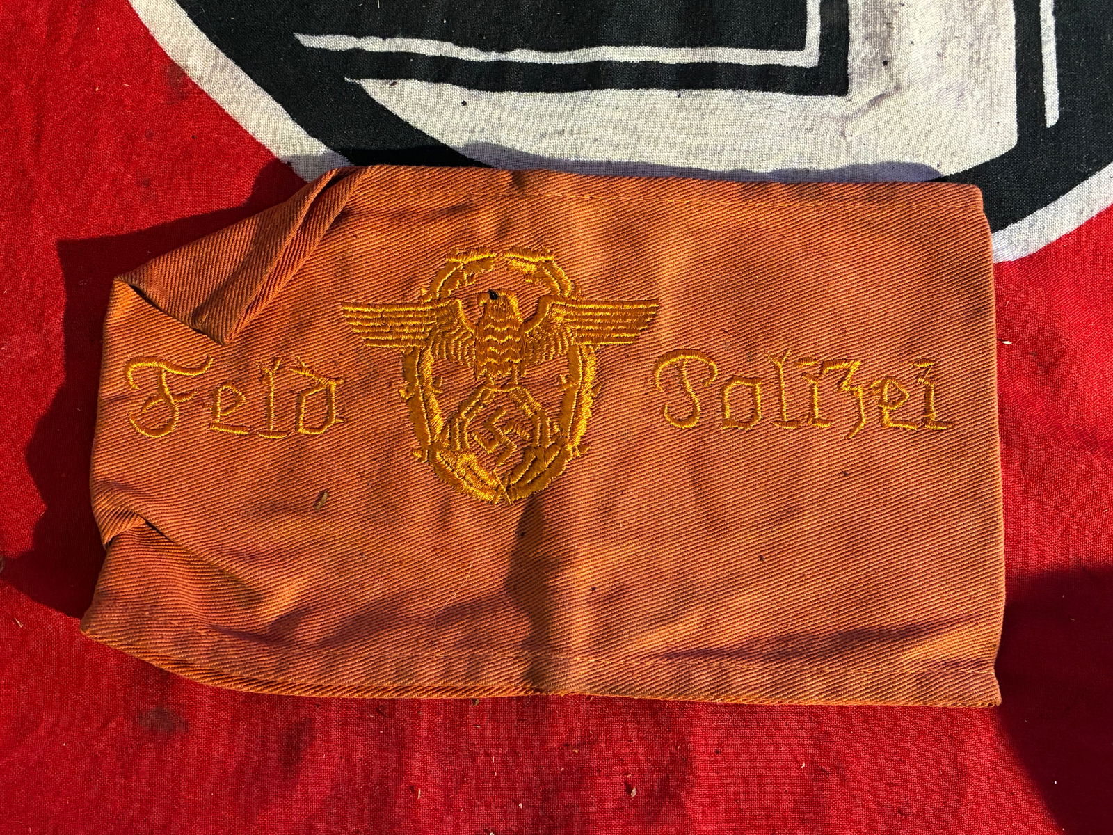 WWII GERMAN THIRD REICH FELD POLIZEI ARMBAND WITH RZM PAPER TAG: WWII GERMAN THIRD REICH FELD POLIZEI ARMBAND WITH RZM PAPER TAG. German Field Police Feld Polizei EM armband. One piece machine embroidered and machine sewn brown cotton construction. RZM tag attached