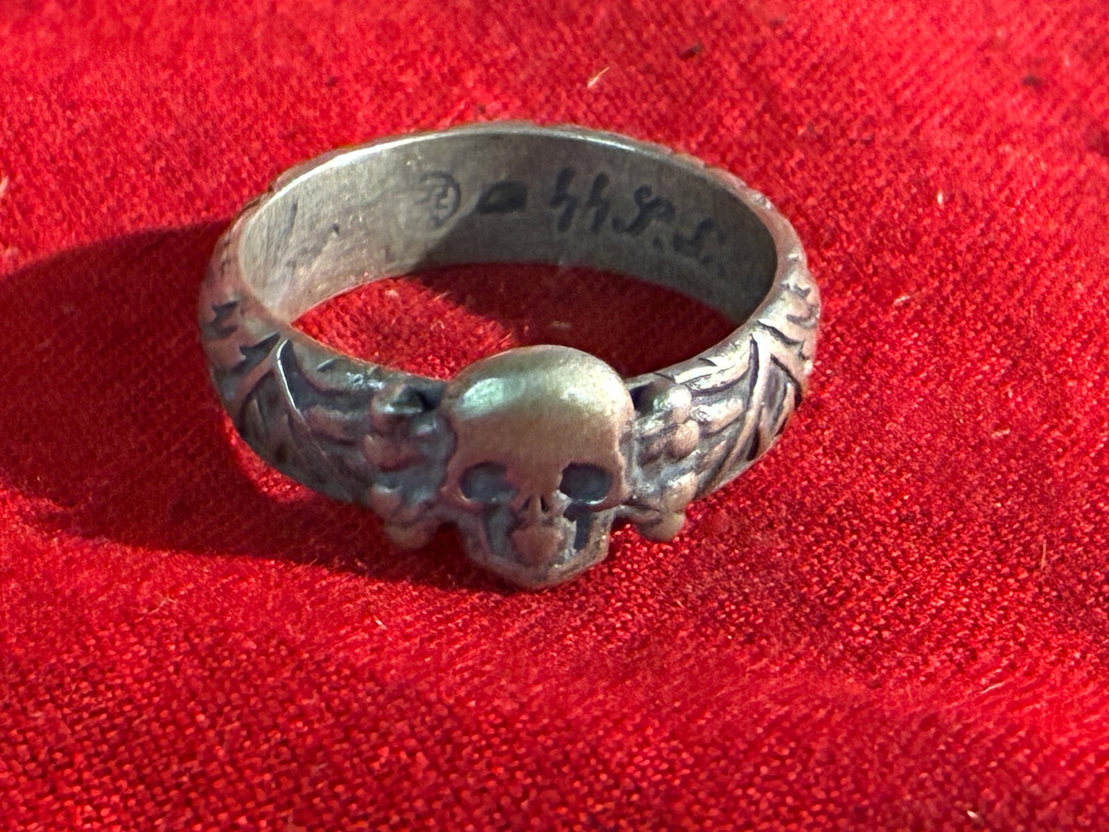 WW2 GERMAN H. HIMMLER TOTENKOPF SS SILVER RING: WW2 GERMAN H. HIMMLER TOTENKOPF SS SILVER RING. AN ULTRA RARE FIND THAT IS IN MINT OVERALL SHAPE AND CONDITION WITH A BEAUTIFUL OVERALL PATINA. SIGNED AND DATER HIMMLER ON THE INSIDE. SHOWS GOOD WEAR 