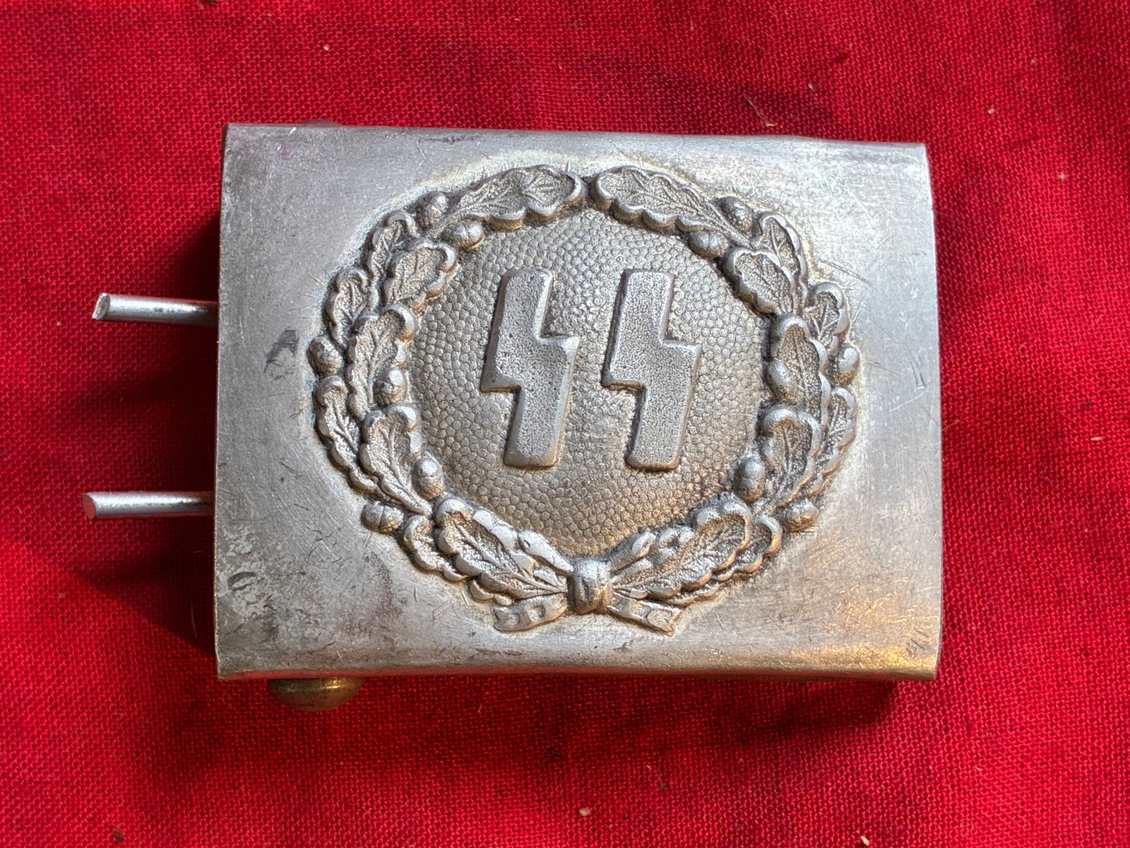 WWII GERMAN THIRD REICH WAFFEN SS BELT BUCKLE BY RAM M34/2: WWII German Waffen SS belt buckle. "R.Z.M. M34/2" maker's marked on the back. SS insignia on the front. Measures 2 X 2.5 inches. Very good condition overall.