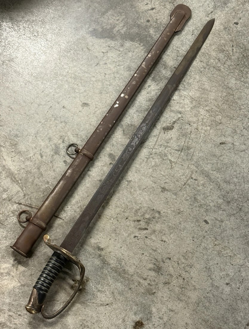 CIVIL WAR CONFEDERATE CSA FULLY ENGRAVED SWORD SABER WITH SHEATH: CIVIL WAR CONFEDERATE CSA FULLY ENGRAVED SWORD SABER WITH SHEATH. A VERY FIND. SHOWS GOOD WEAR AND USE WITH A BEAUTIFUL OVERALL PATINA. FULLY ENGRAVED BLADE. COMES WITH THE ORIGINAL SCABBARD. MARKED C