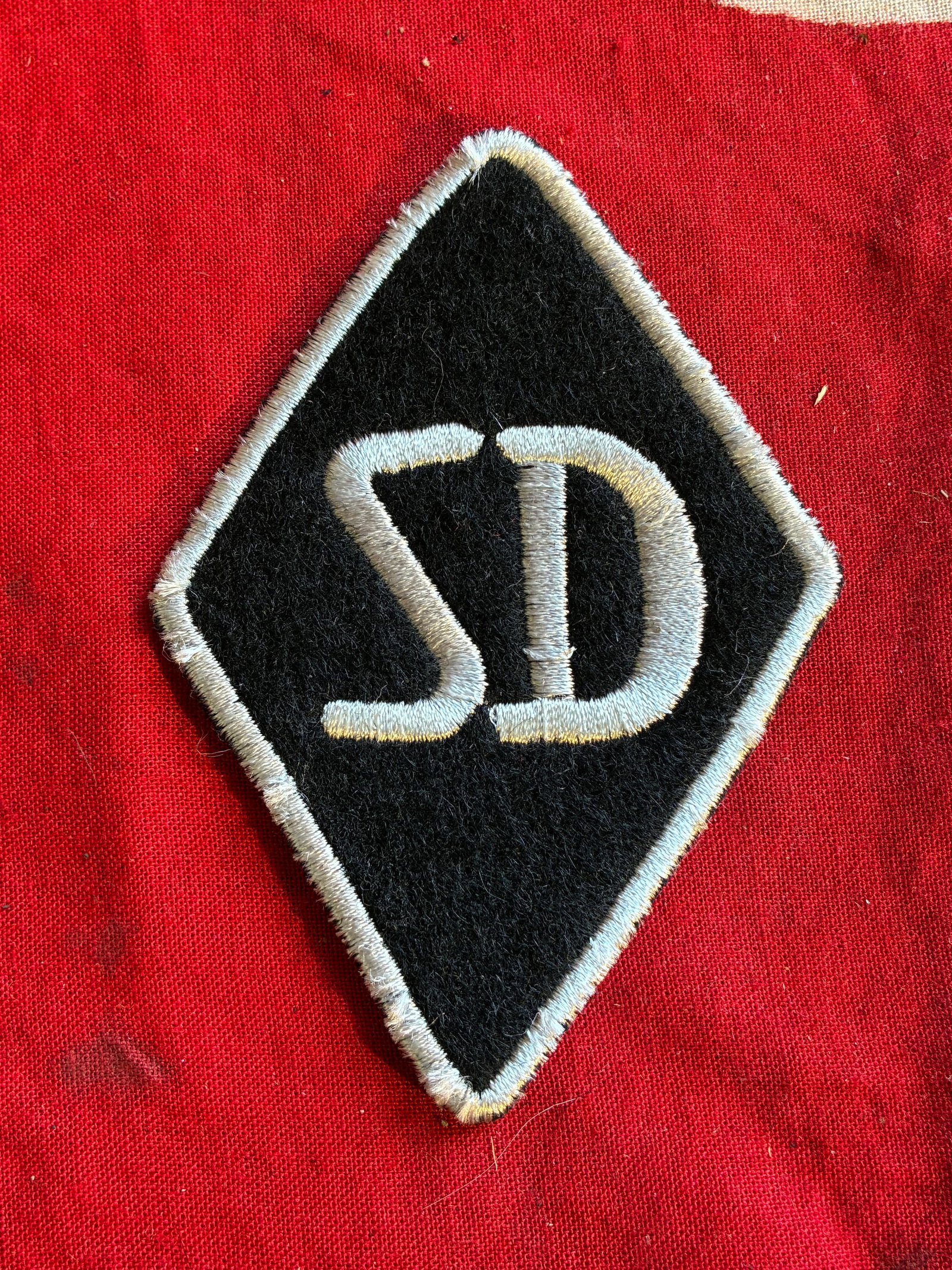 WW2 German SD Arm Badge / Sicherheitsdienst Diamond: WW2 German SD Arm Badge / Sicherheitsdienst Diamond. A rare find. Shows good wear and use with a beautiful overall patina. Please view all detailed pictures. A scarce example of the time period.