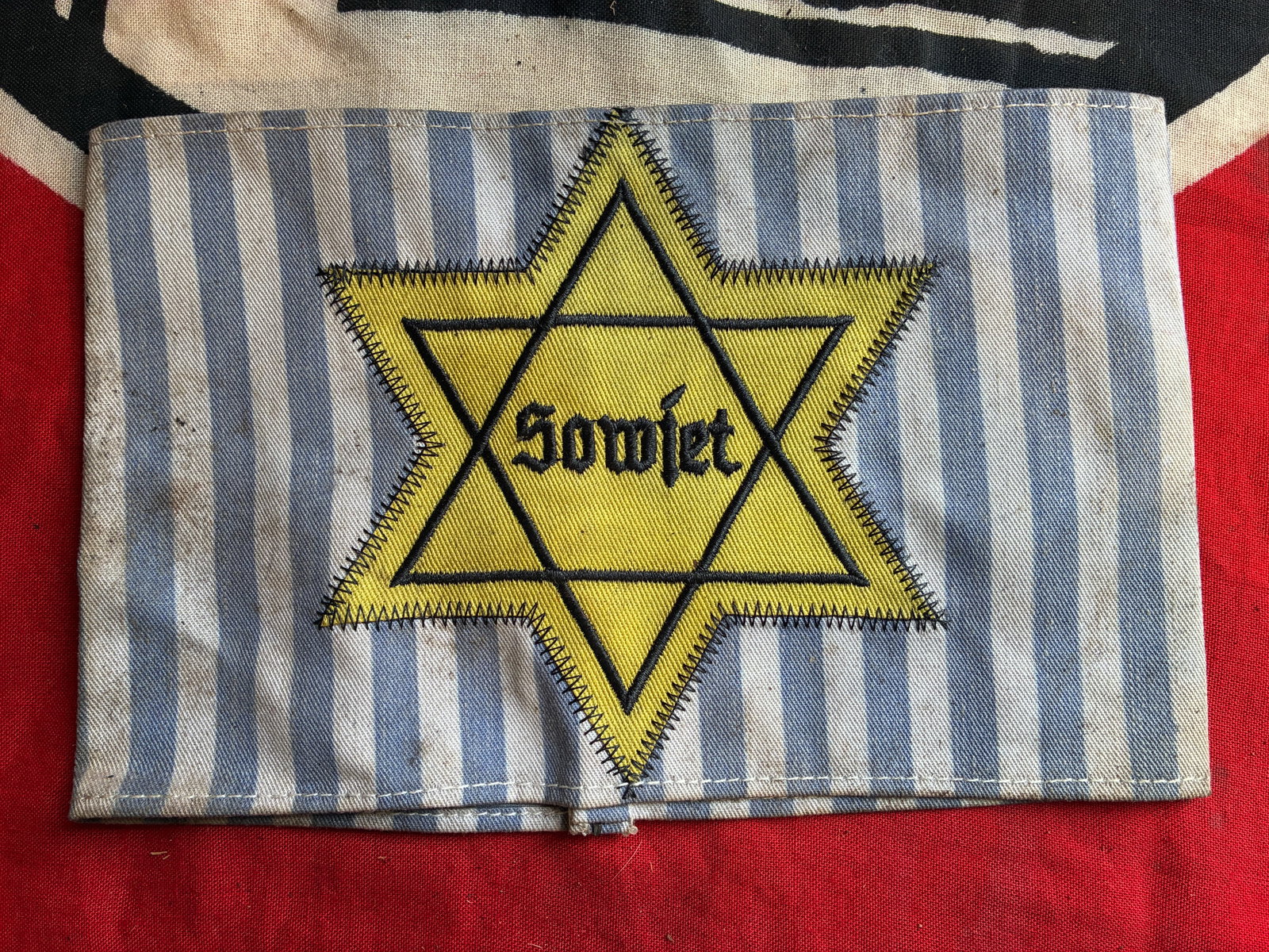 WW2 GERMAN SOVIET RUSSIAN SOWJET STAR OF DAVID CONCENTRATION CAMP UNIFORM ARMBAND: WW2 GERMAN SOVIET RUSSIAN SOWJET STAR OF DAVID CONCENTRATION CAMP UNIFORM ARMBAND. A VERY RARE FIND WITH THE ATTACHMENTS LOOPS STILL ATTACHED TO THE REVERSE. SHOWS GOOD WEAR AND USE WITH A BEAUTIFUL P