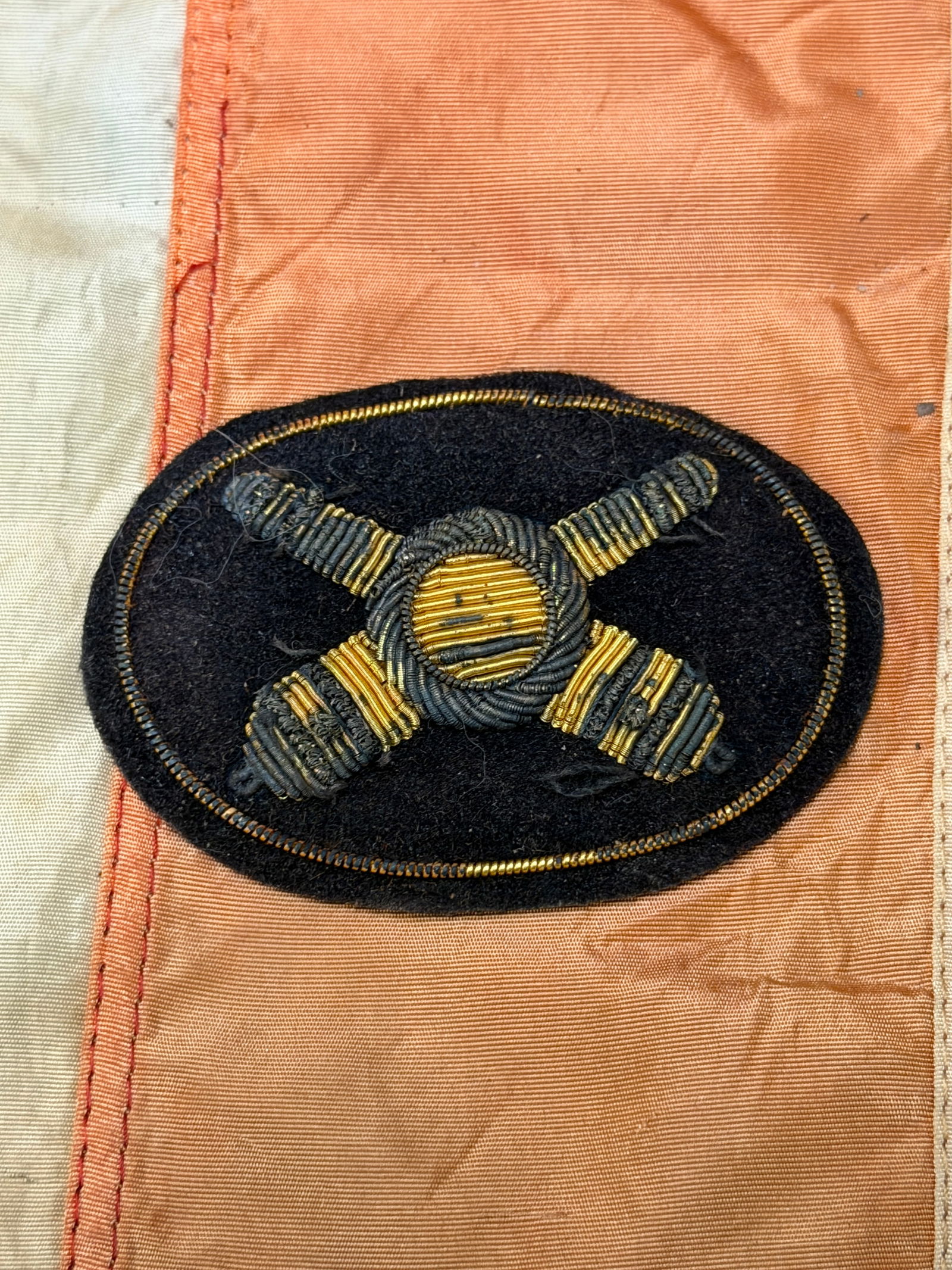 CIVIL WAR ARTILLERY BULLION HEADGEAR BADGE BY JOHN A. BAKER: CIVIL WAR ARTILLERY BULLION HEADGEAR BADGE BY JOHN A. BAKER. A RARE FIND. SHOWS GOOD WEAR AND USE WITH A BEAUTIFUL OVERALL PATINA. HAS A GREAT LOOK TO IT WITH AN EXCELLENT OVERALL EYE APPEAL. A RARE F