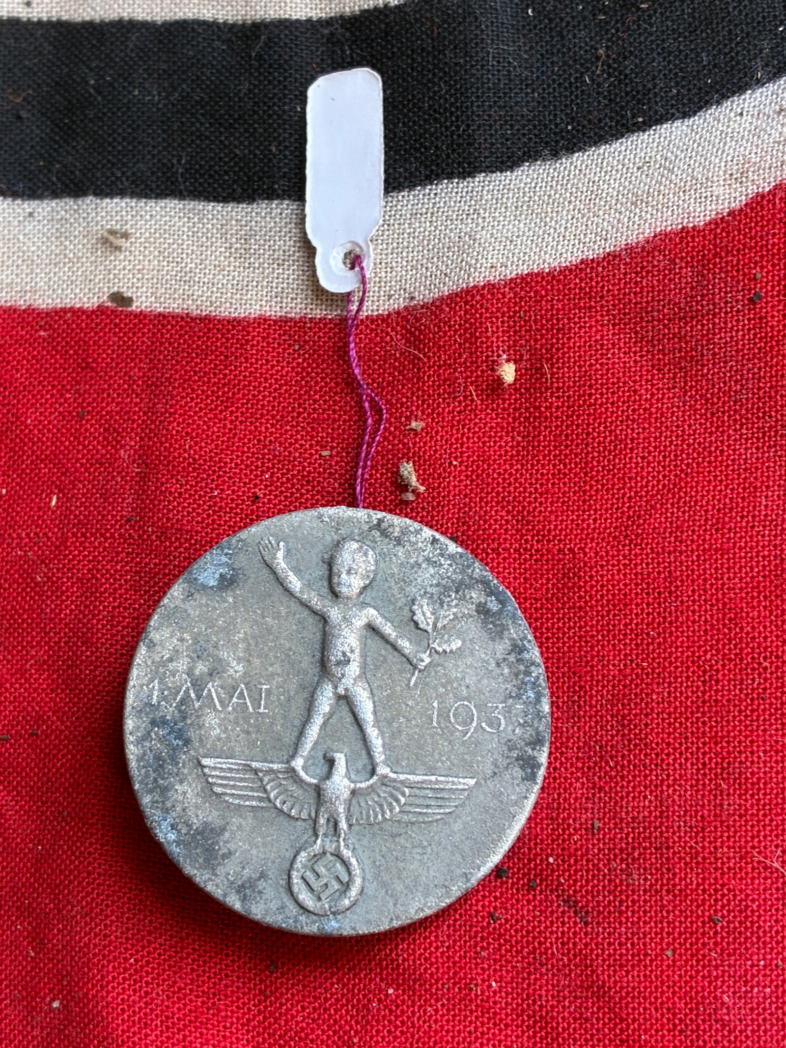 WW2 German May Day Badge 1937 Tinnie: WW2 German May Day Badge 1937 Tinnie. German May Day Badge 1937/Near mint 1937 May Day badge, maker marked, pin back, still has lacquer finish..