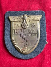 WW2 German Kuban Sleeve Sheild in Zinc Bronzed ON Dark Blue Cloth Backing
