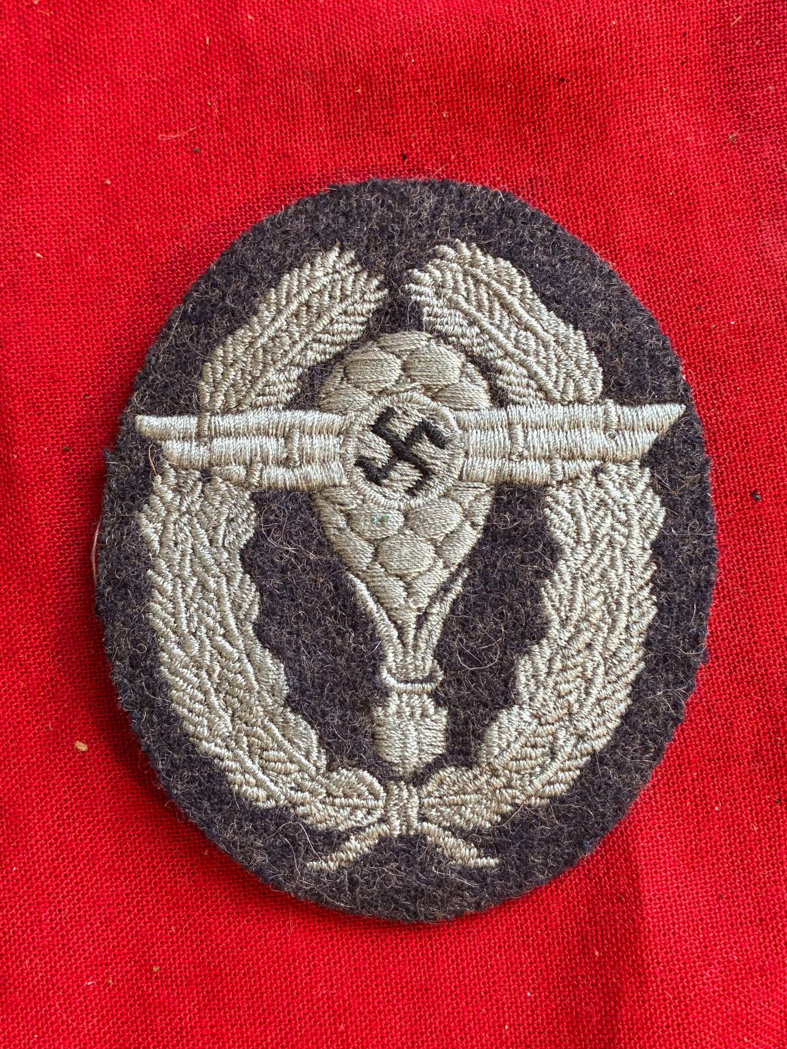 WWII GERMAN NSFK BALLOON PILOT BULLION PATCH: WWII German NSFK Balloon Pilot Qualification Insignia. Silver bullion thread embroidered on felt. Size: 2 1/4" x 2 1/2".