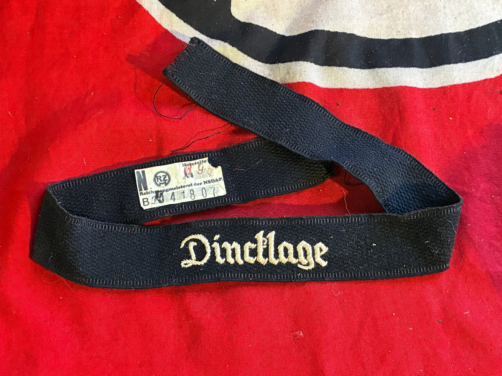 WW2 GERMAN WAFFEN SS DINDLAGE CUFF TITLE WITH RZM PAPER TAG: WW2 GERMAN WAFFEN SS DINDLAGE CUFF TITLE WITH RZM PAPER TAG. A RARE FIND. SHOWS GOOD WEAR AND USE WITH A BEAUTIFUL OVERALL PATINA. PLEASE VIEW ALL DETAILED PICTURES. A RARE FIND.