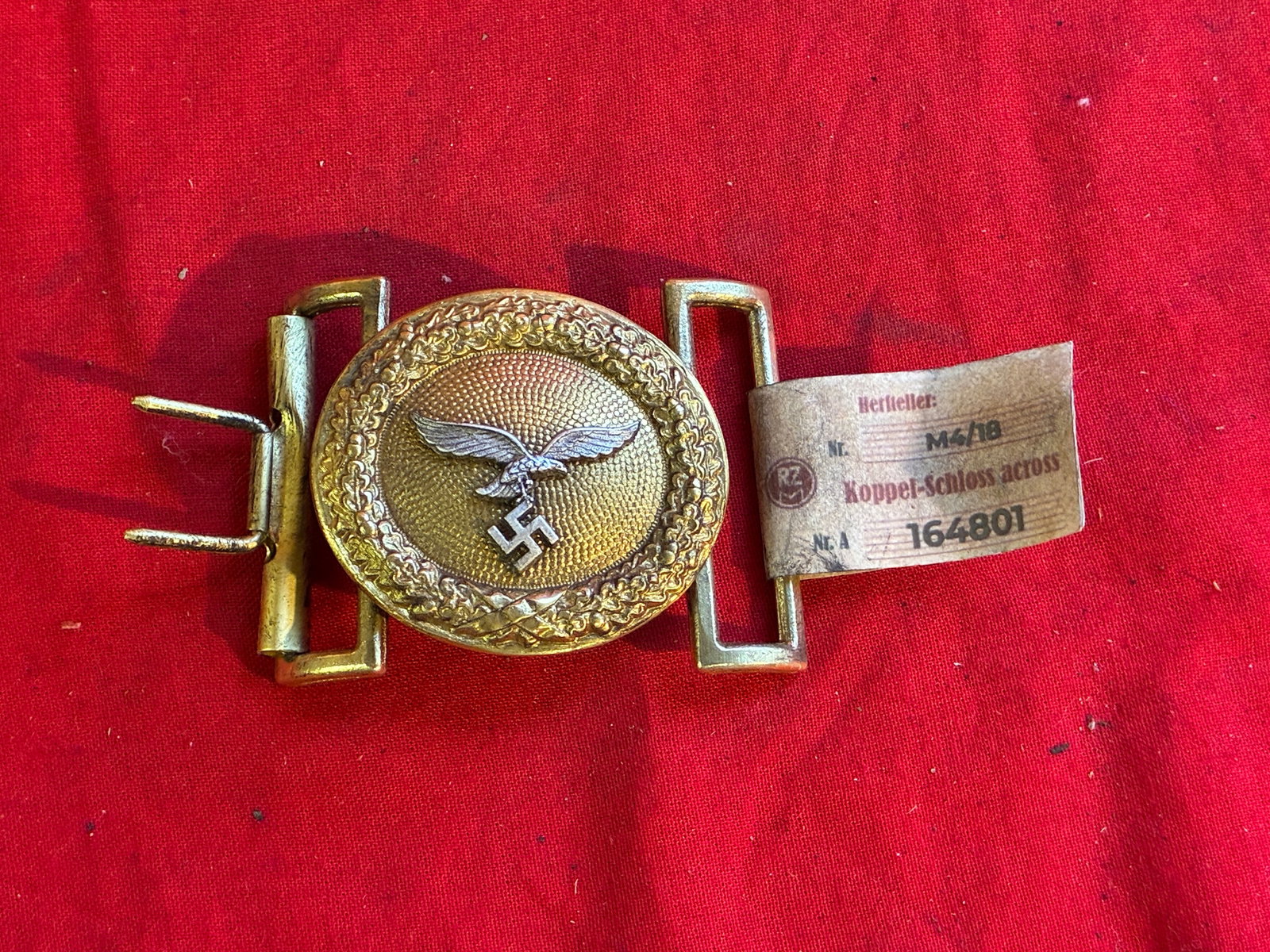 WWII GERMAN LUFTWAFFE OFFICER OVAL BELT BUCKLE WITH RZM PAPER TAG: WWII GERMAN LUFTWAFFE OFFICER OVAL BELT BUCKLE WITH RZM PAPER TAG. WWII German Luftwaffe belt buckle. Golden color featuring a silver Luftwaffe eagle to center with a pebbled background all surrounded