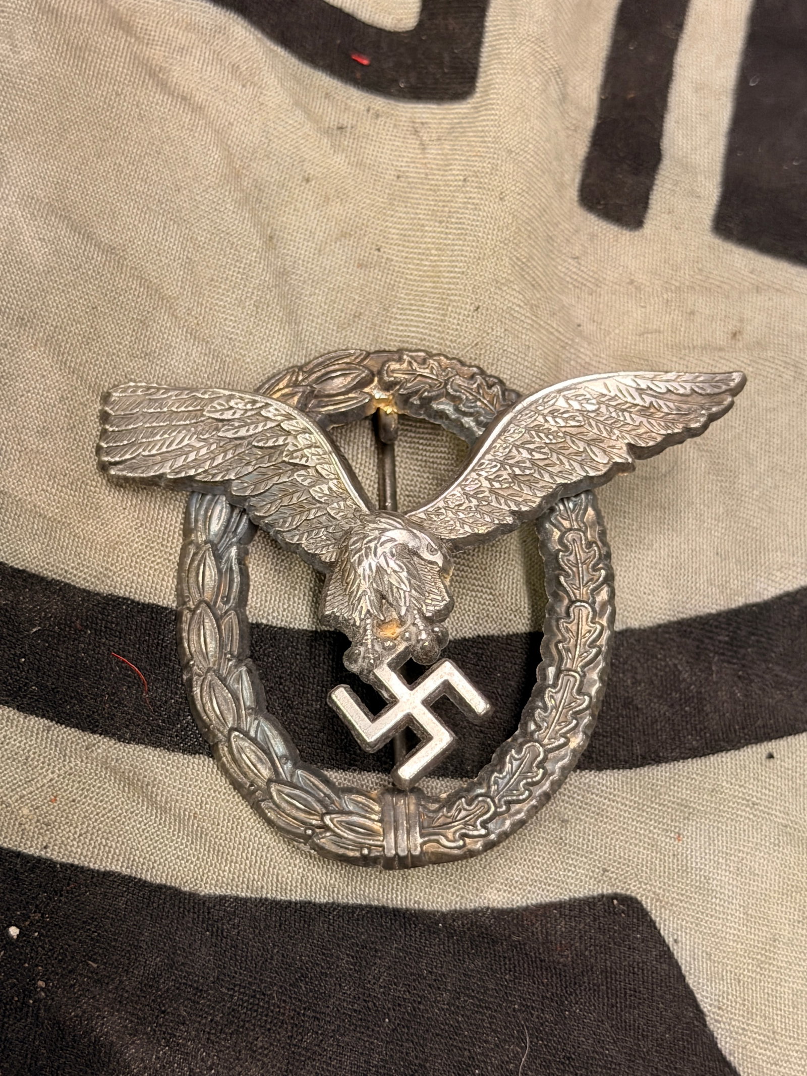 German WWII Luftwaffe Pilot Badge By Assmann: German WWII Luftwaffe Pilot Badge By Assmann. Maker marked on the reverse. Shows good wear and use with a beautiful overall patina. Shows good wear and use. Please view all detailed pictures. A rare e