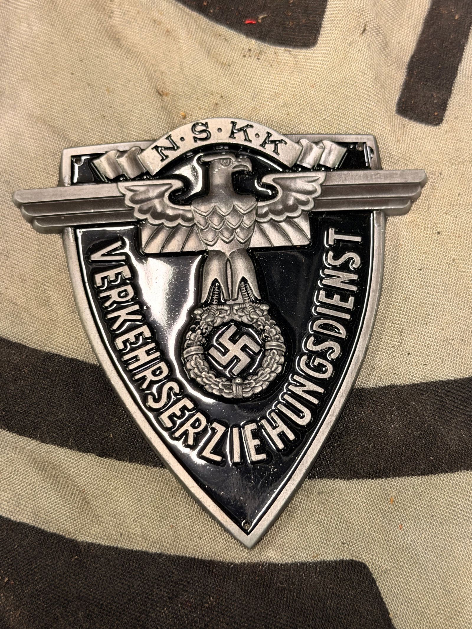 WWII German NSKK Traffic Education Sleeve Shield: WWII German NSKK Traffic Education Sleeve Shield. Well made, curved aluminum sleeve shield with mounting holes in each corner. Shows good wear and use with a beautiful overall patina. Please view all 