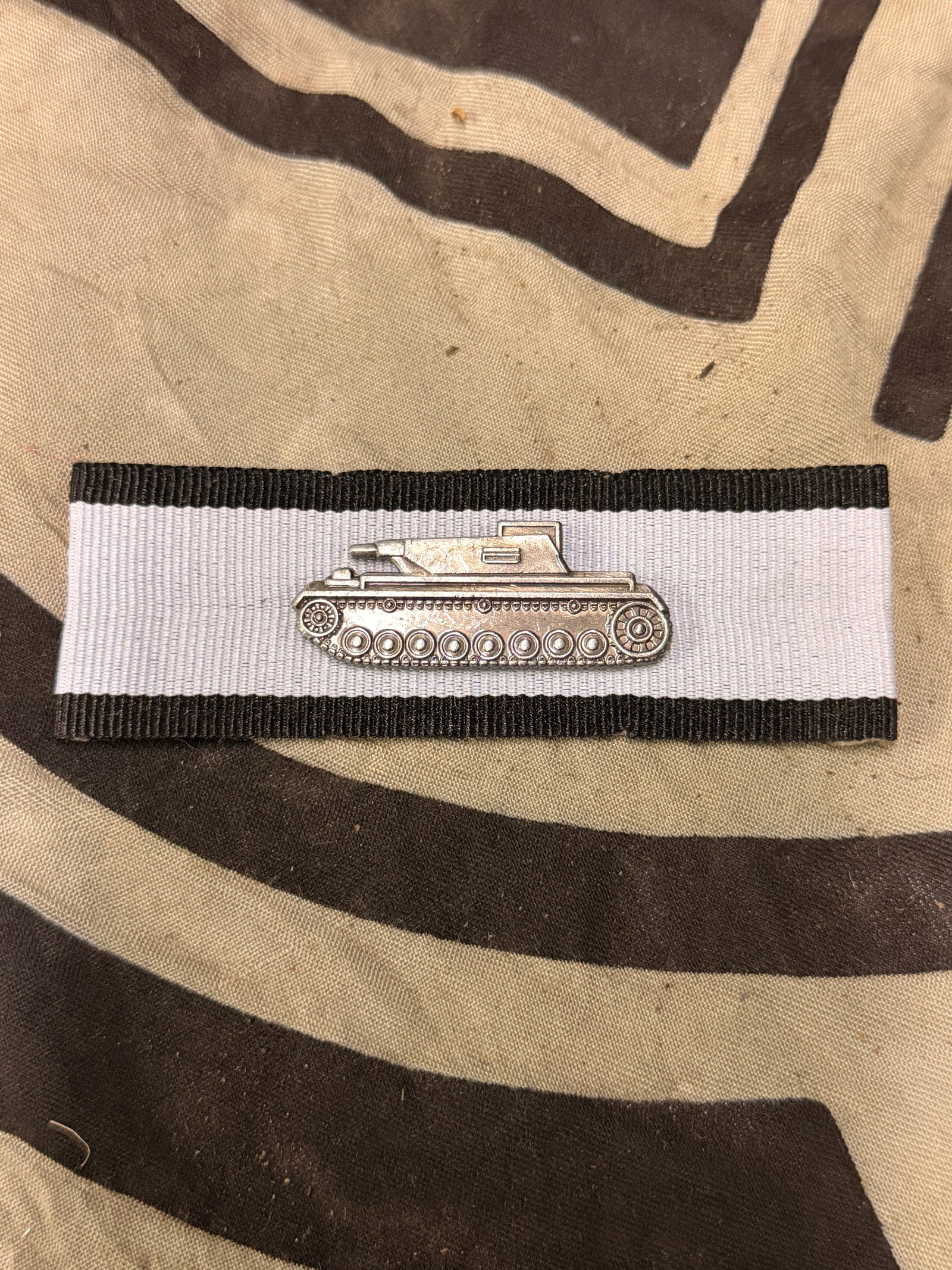 WWII German Tank Destroyer Badge In Silver: WWII German Tank Destroyer Badge In Silver. A RARE EXAMPLE. SHOWS GOOD WEAR AND USE WITH A BEAUTIFUL OVERALL PATINA. PLEASE VIEW ALL DETAILED PICTURES. A RARE EXAMPLE OF THE TIME PERIOD.
