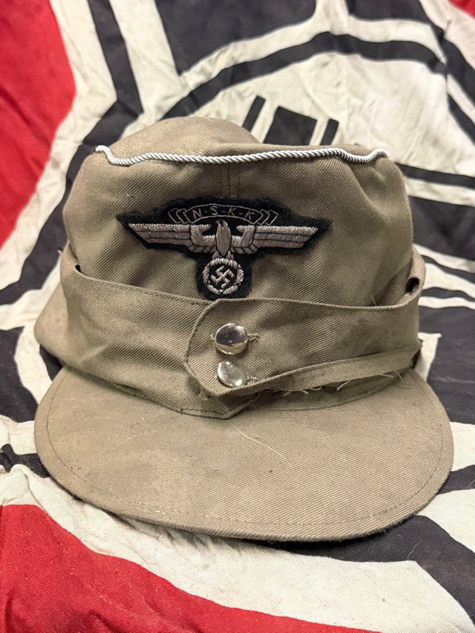 German WWII M43 NSKK National Socialist Motor Corps Officers Feldmütze Field Cap: German WWII M43 NSKK National Socialist Motor Corps Officers Feldmütze Field Cap. This is fantastic "salty" heavily service worn NSKK Officer's M43 Feldmütze (Field Cap). Very similar to the Heer Ar
