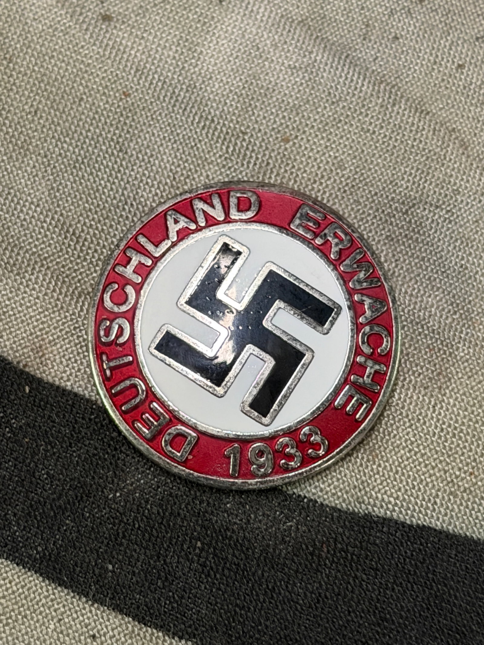 WW2 GERMAN NSDAP PARTY "DEUTSCHLAND ERWACHE" LAPEL ENAMELED PIN BY RZM M1/129: WW2 GERMAN NSDAP PARTY "DEUTSCHLAND ERWACHE" LAPEL ENAMELED PIN BY RZM M1/129. A RARE EXAMPLE THAT IS IN MINT OVERALL SHAPE AND CONDITION WITH A BEAUTIFUL OVERALL PATINA. SHOWS GOOD WEAR AND USE. PLEA