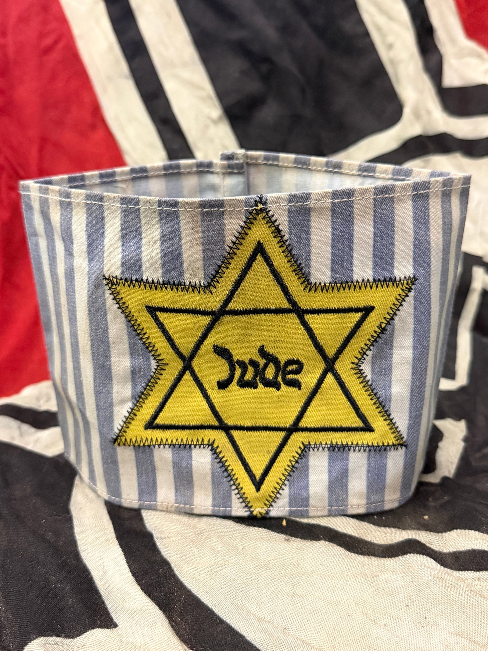 WW2 GERMAN CONCENTRATION CAMP JUDE JEWISH PRISONER ARMBAND: WW2 GERMAN CONCENTRATION CAMP JUDE JEWISH PRISONER ARMBAND. A VERY RARE FIND. SHOWS GOOD WEAR AND USE WITH A BEAUTIFUL OVERALL PATINA. HAS THE STAR OF DAVID STITCHED TO THE CAMP MATERIAL USED ON UNIFO