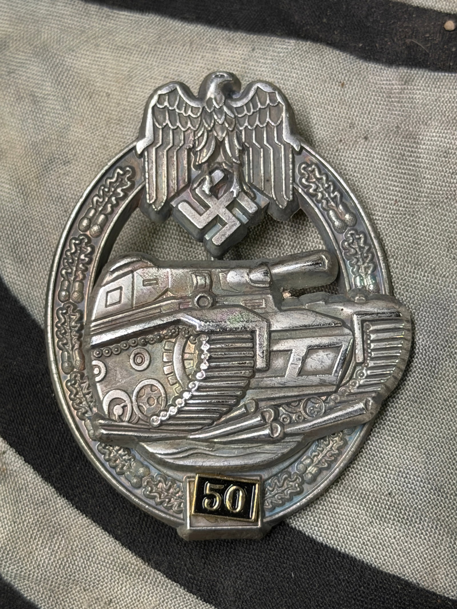 WW2 German Army / Waffen SS Special Grade 50 Engagements Panzer Assault Badge By JFS: WW2 German Army / Waffen SS Special Grade 50 Engagements Panzer Assault Badge By JFS. The badge is heavy, multi-piece, riveted construction. The brighter finish of the wreath and eagle is largely inta