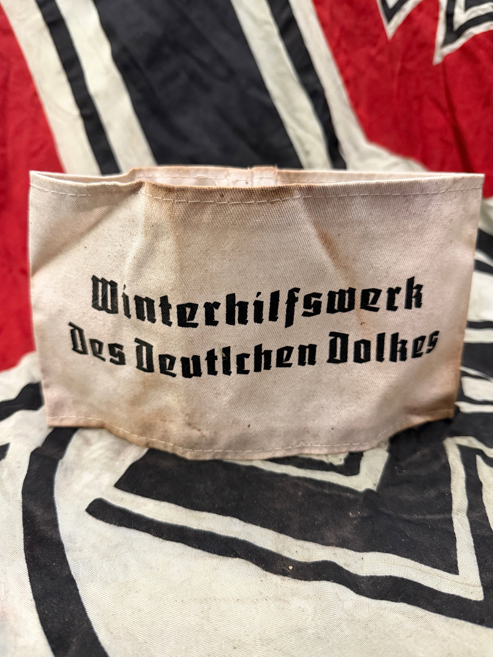 WW2 GERMAN WINTERHILFSWERK DES DEUTSCHEN VOLKES ARMBAND: WW2 GERMAN WINTERHILFSWERK DES DEUTSCHEN VOLKES ARMBAND. A RARE FIND. SHOWS GOOD WEAR AND USE WITH A BEAUTIFUL OVERALL PATINA. PLEASE VIEW ALL DETAILED PICTURES. A SCARCE EXAMPLE OF THE TIME PERIOD.